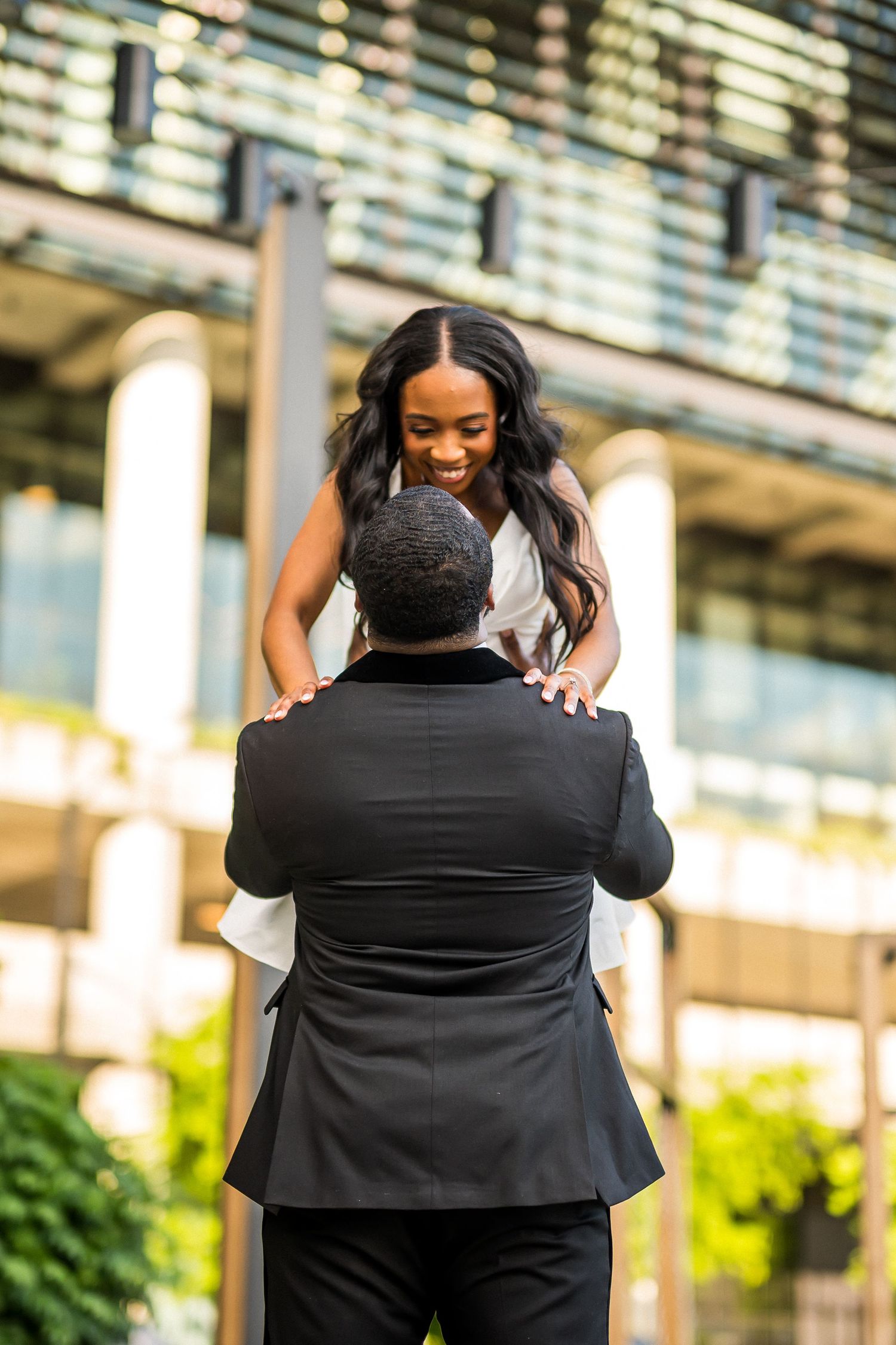Couple shares emotional first look moment in urban setting.