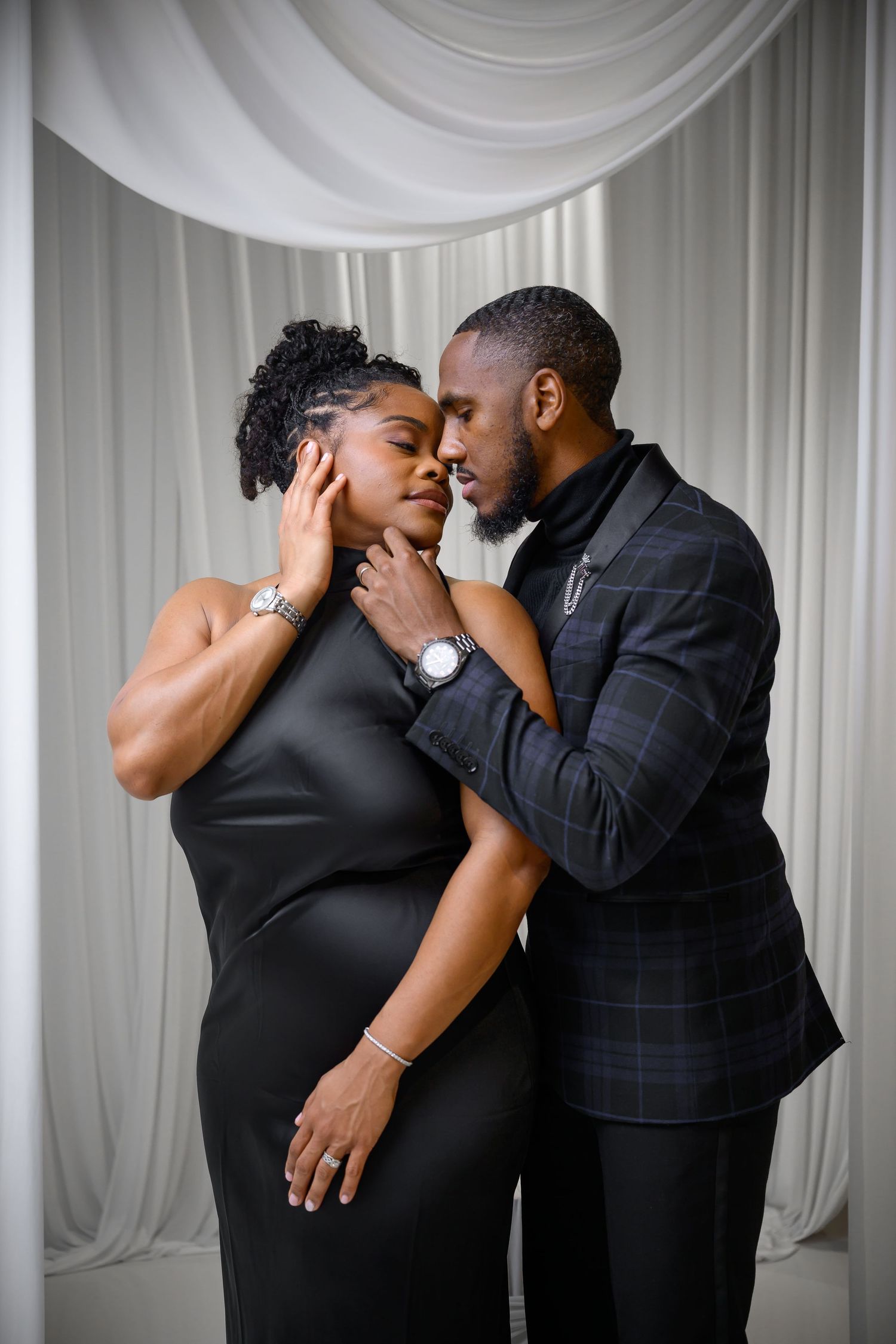A romantic sequence of three photos showing a couple in formal black attire sharing intimate kisses against a white backdrop.
