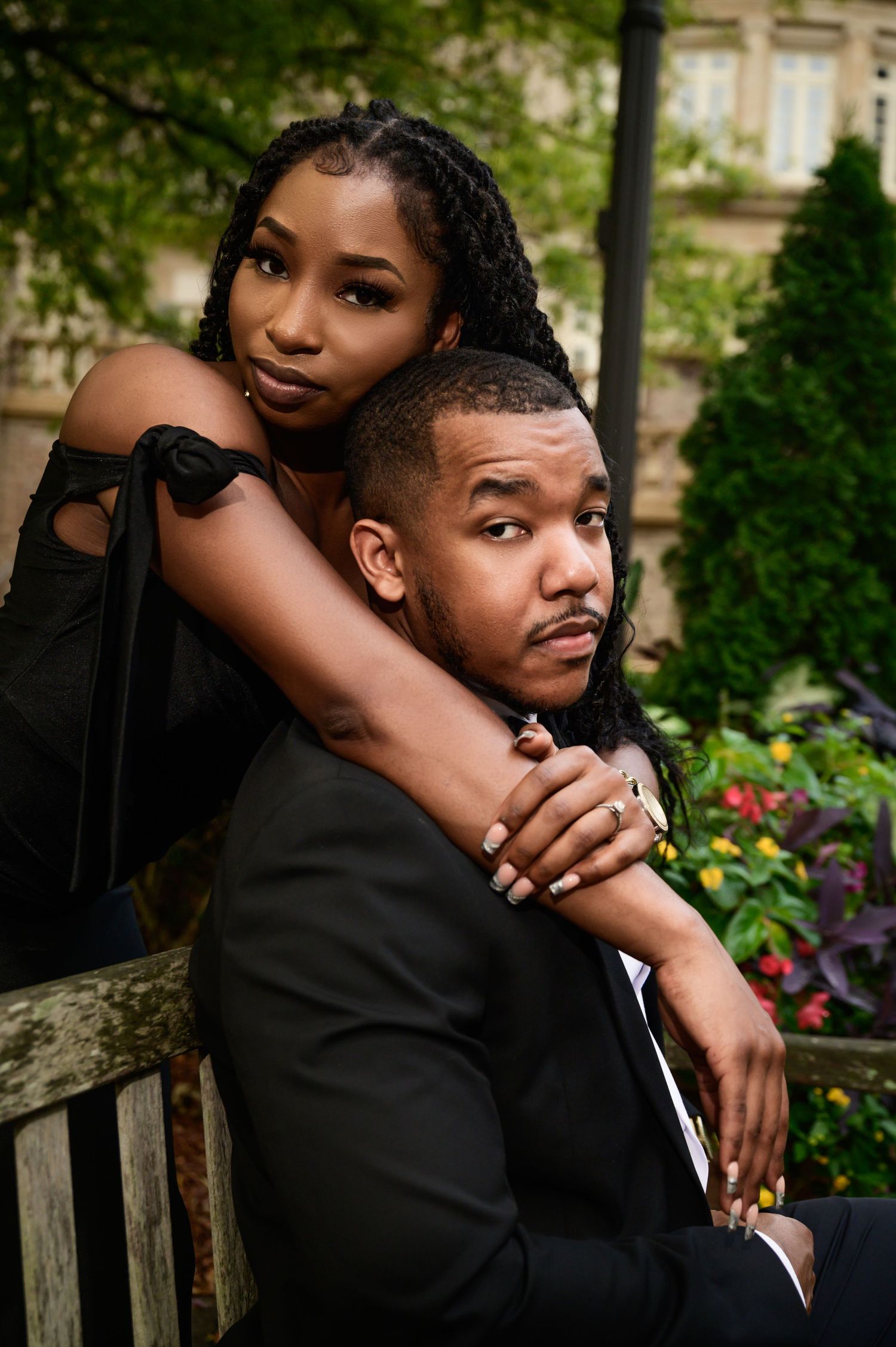 Intimate portrait session in a garden setting with formal attire.