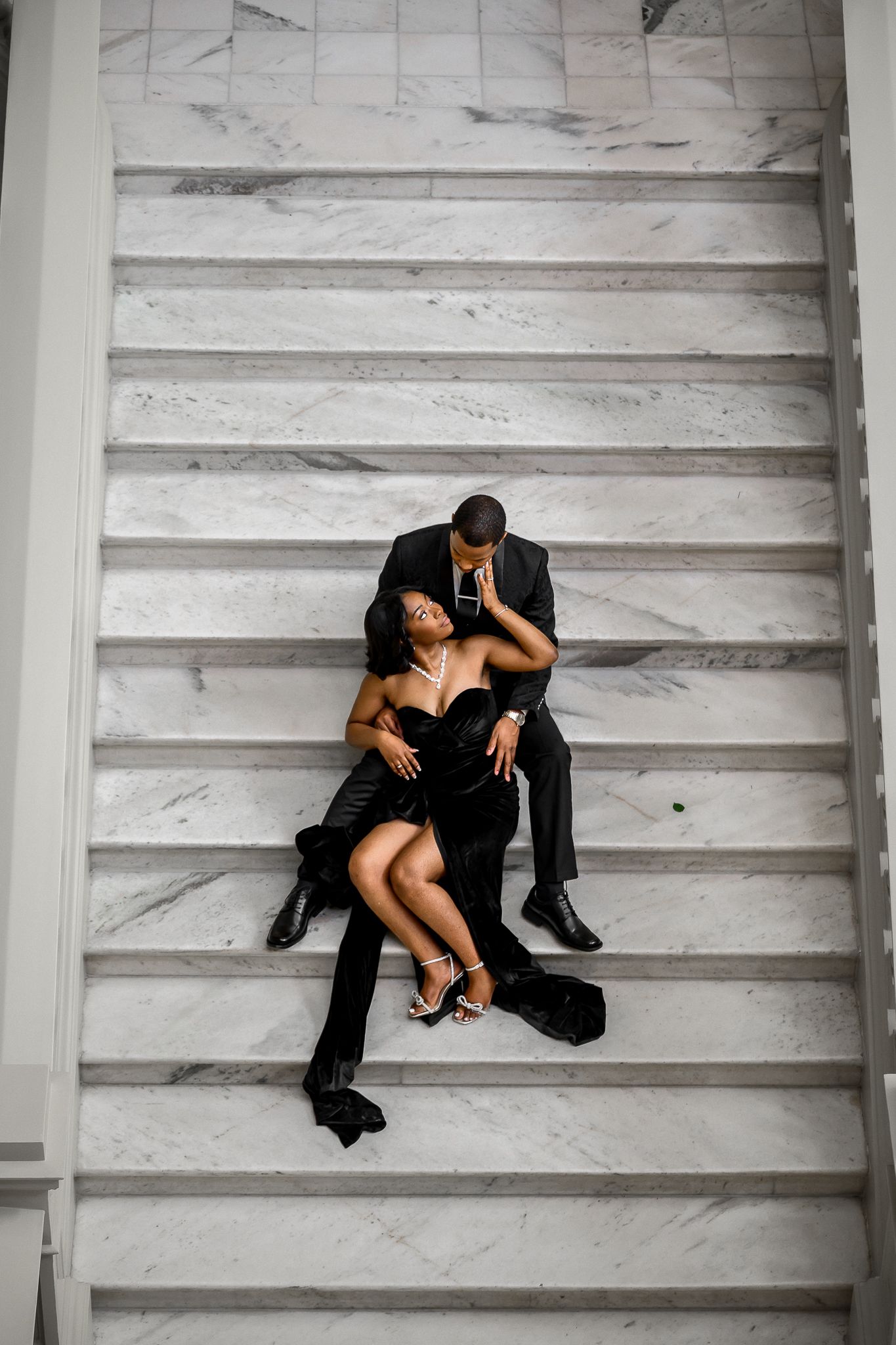 Artistic sequence of couple lounging on white marble steps in formal attire.