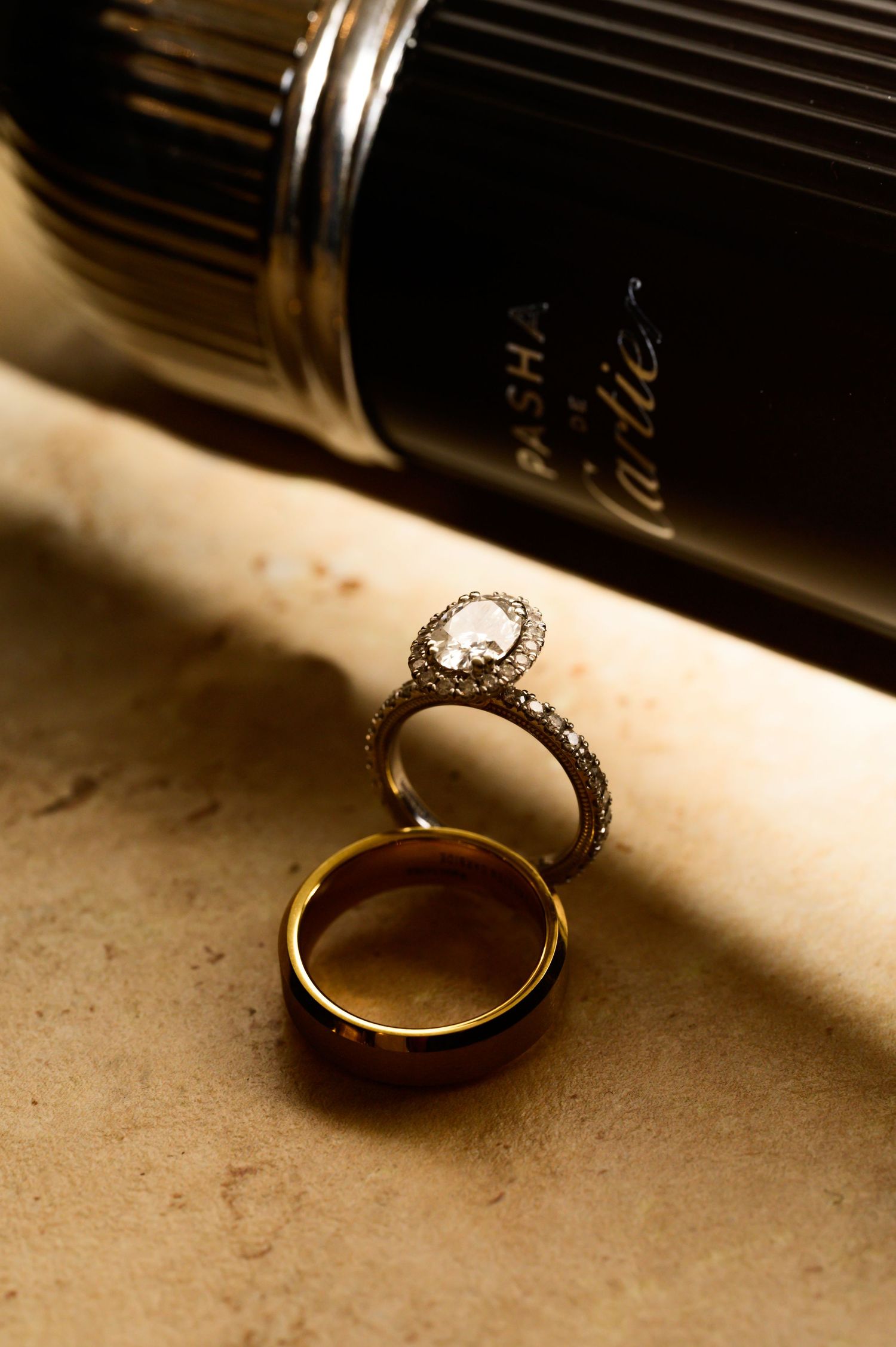 Wedding rings casting dramatic shadows in artistic still life composition.