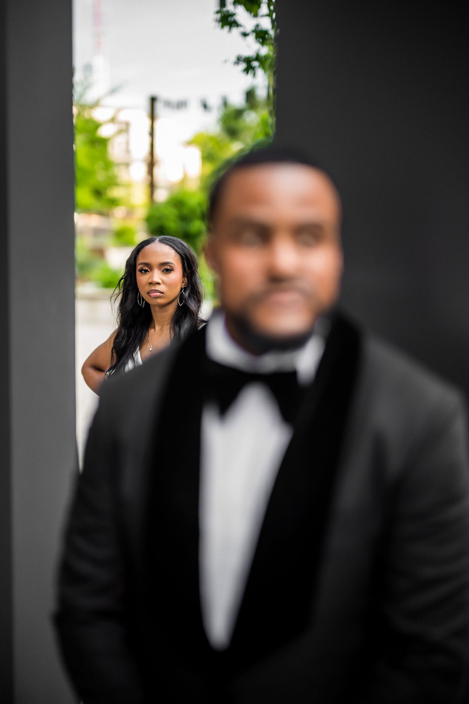 Artistic portrait with selective focus in modern outdoor setting.