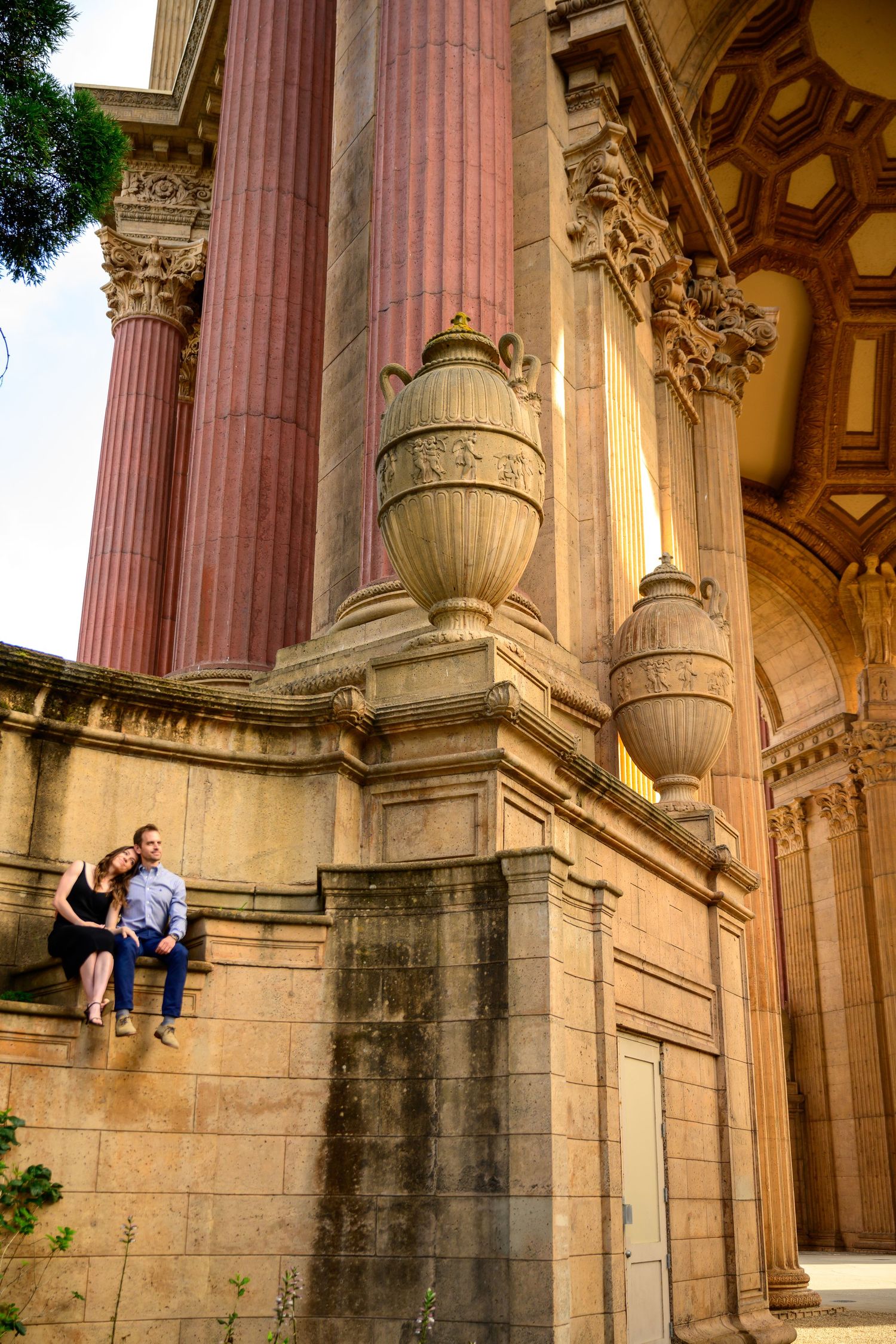 A romantic photoshoot at the Palace of Fine Arts featuring classical architecture and columns.