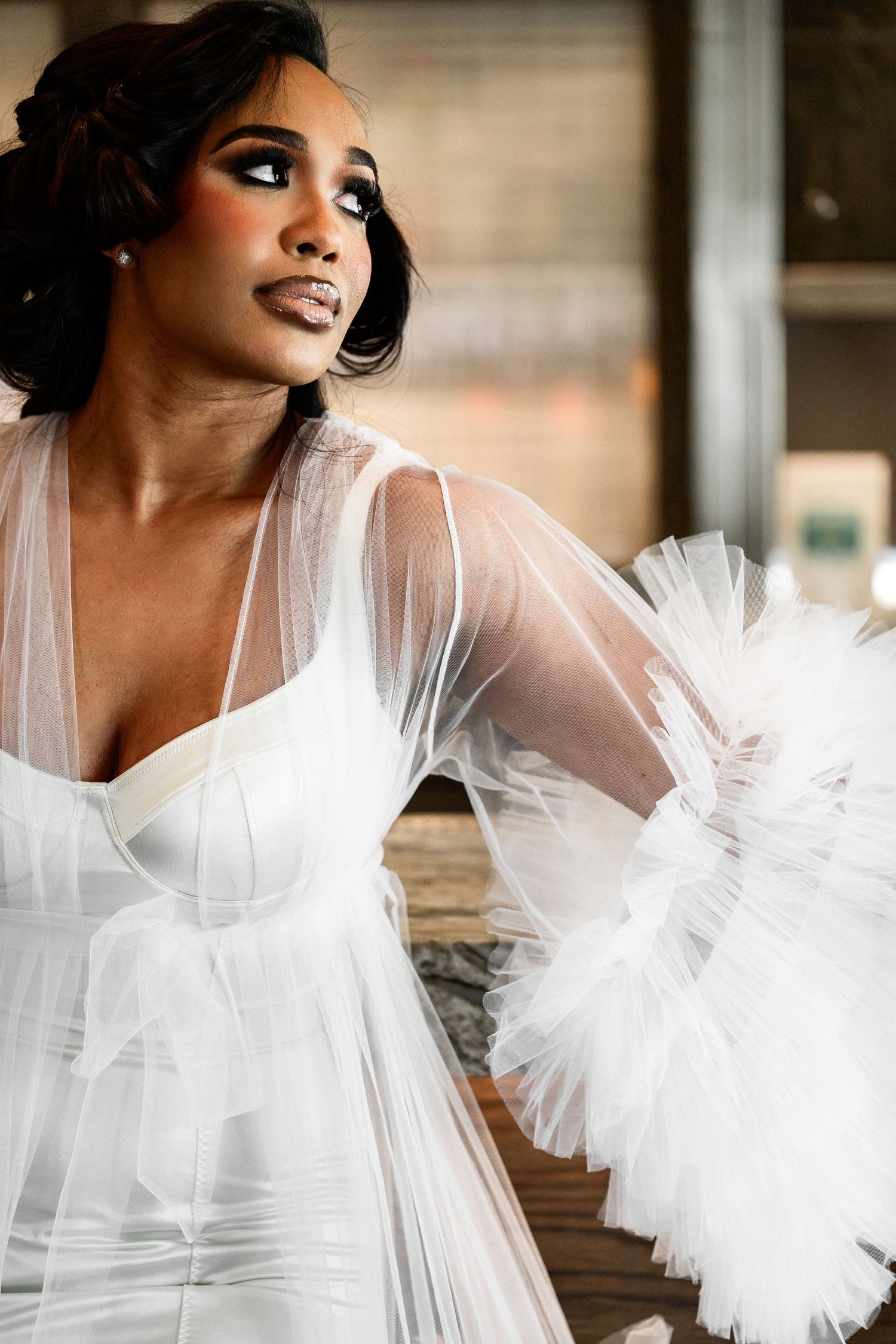 Ethereal bridal portrait with flowing white tulle and romantic lighting.