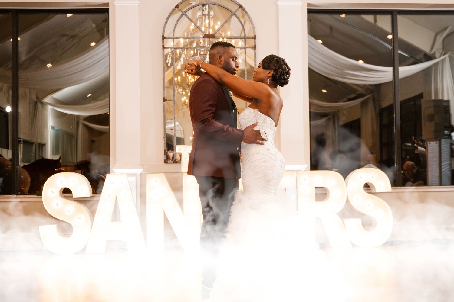 Wedding reception venue with elegant lighting and decor.