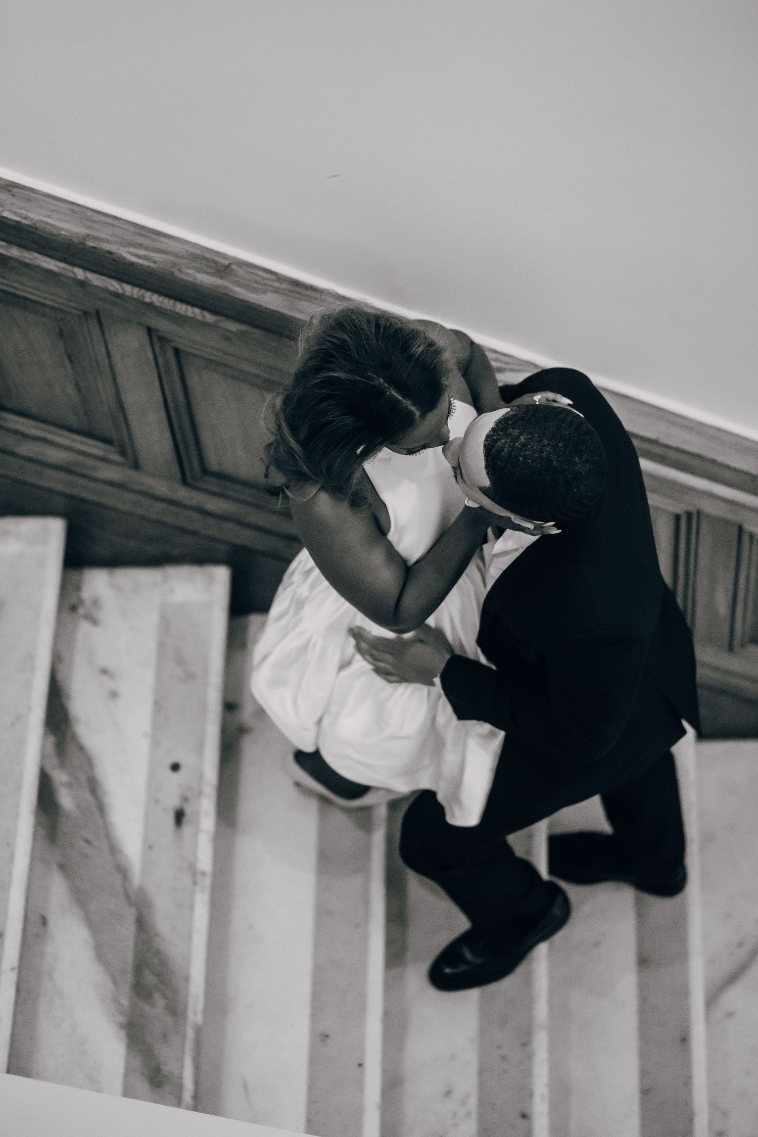 Artistic black and white photo sequence of a couple on marble stairs.