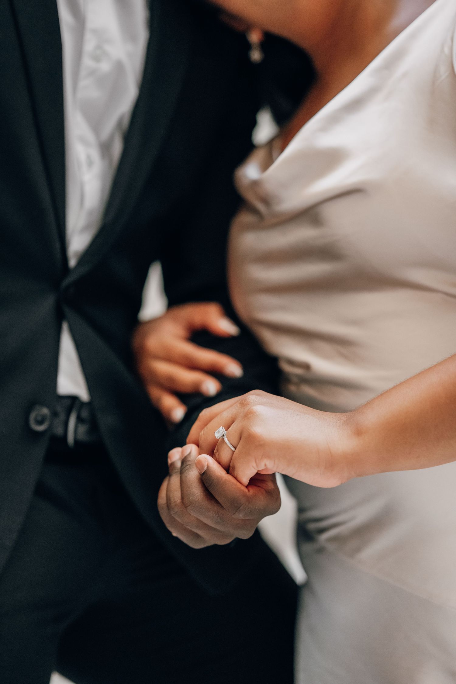 Close-up of hands exchanging wedding rings during an elegant ceremony.