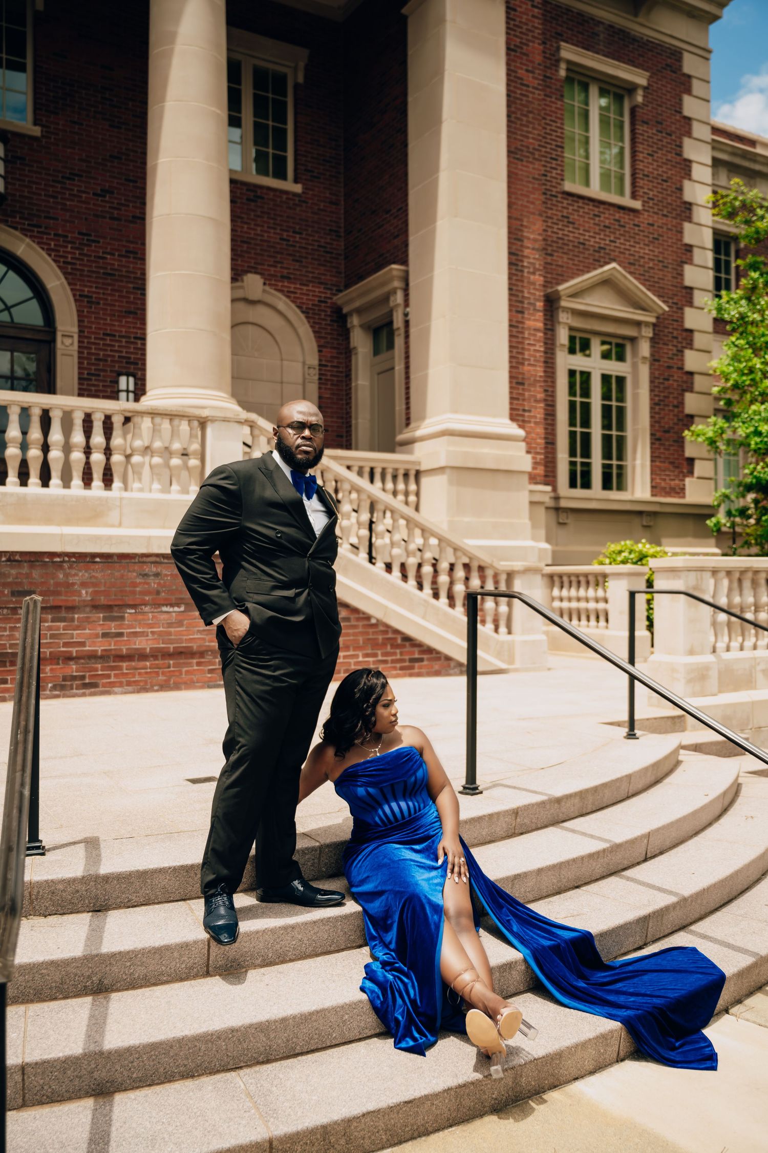 Dramatic portrait series of couple in formal wear on architectural steps with columns.