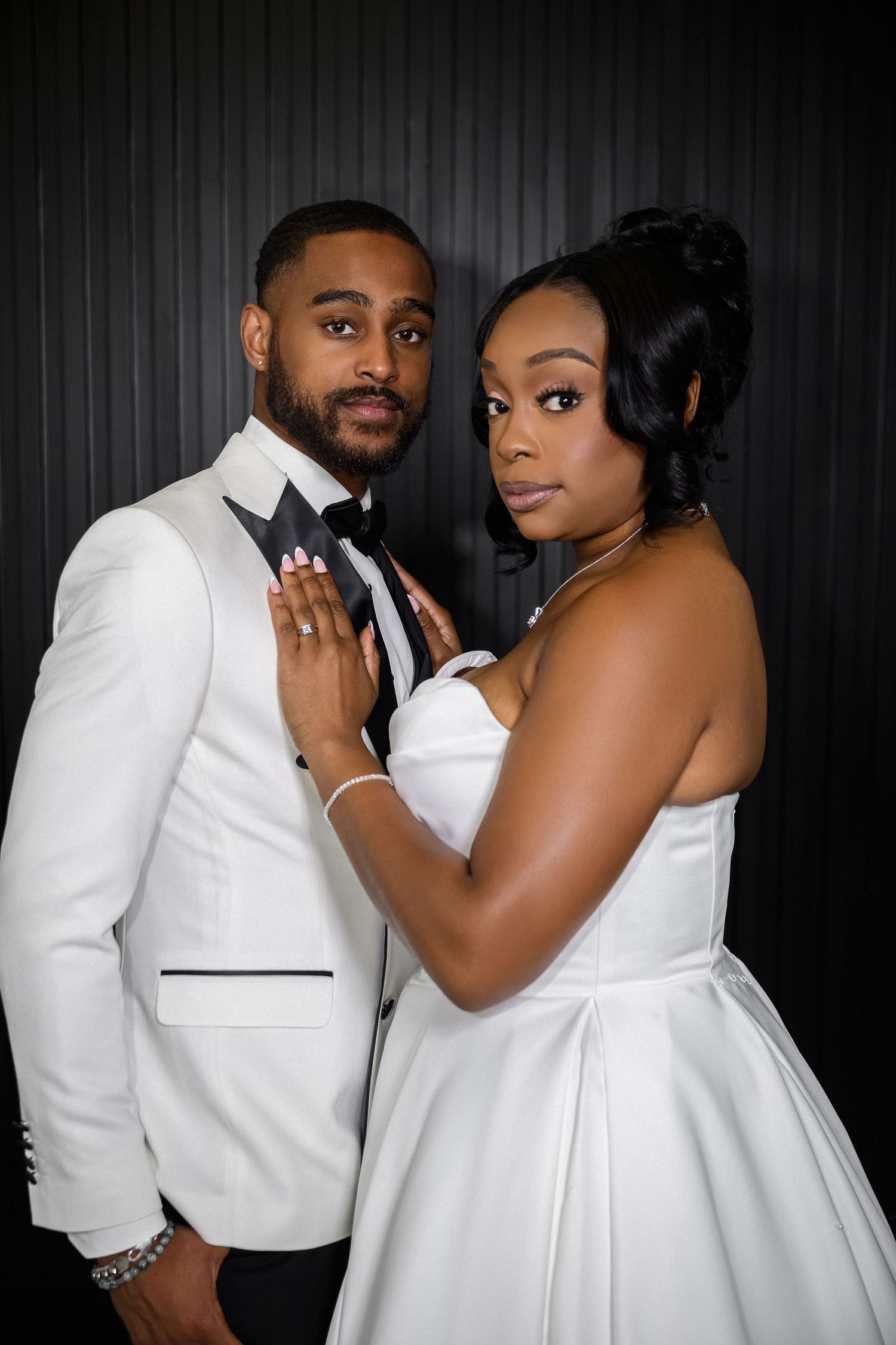 A romantic couple in matching white formal attire pose together in a series of intimate photo booth style shots.