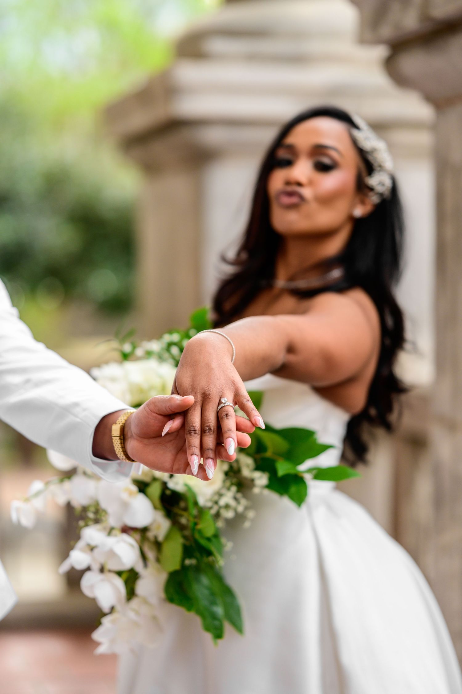 Wedding party members holding white floral bouquets pose in sequence outdoors.