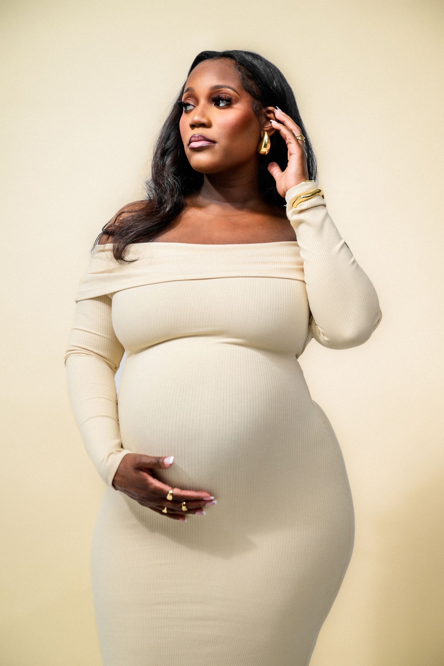 Maternity photography showcasing cream off-shoulder dress and natural poses.