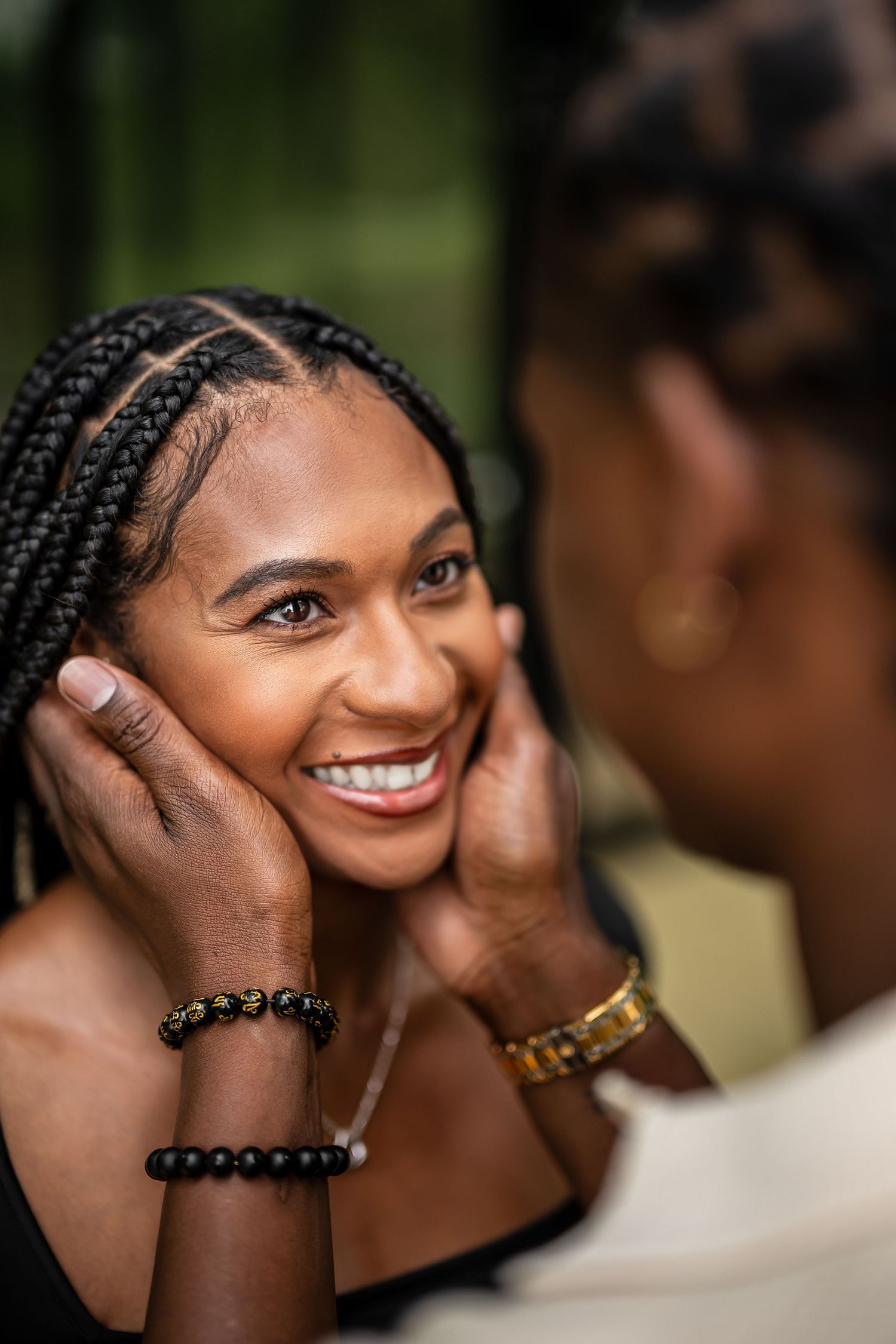Close-up portrait showing joyful expressions during an intimate greenhouse photoshoot.