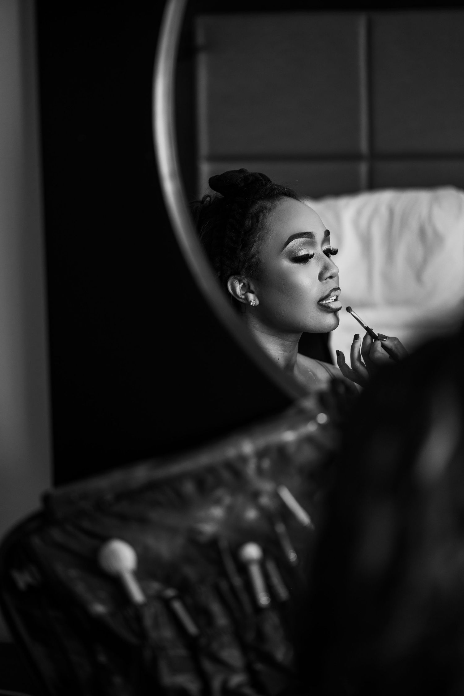 Artistic black and white profile portrait in dramatic lighting.