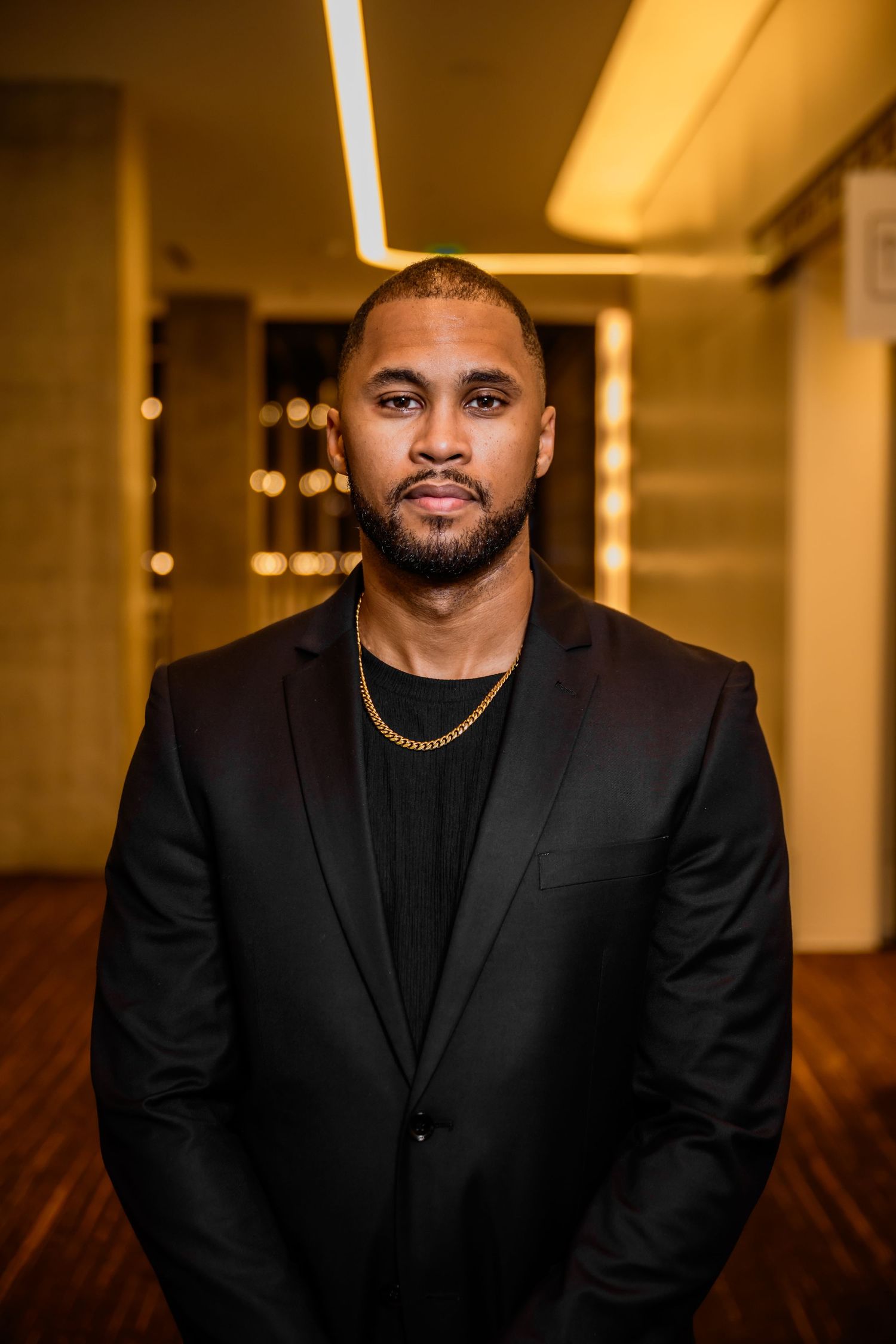 A series of portraits in a warmly lit hallway showing professional attire and confident poses.