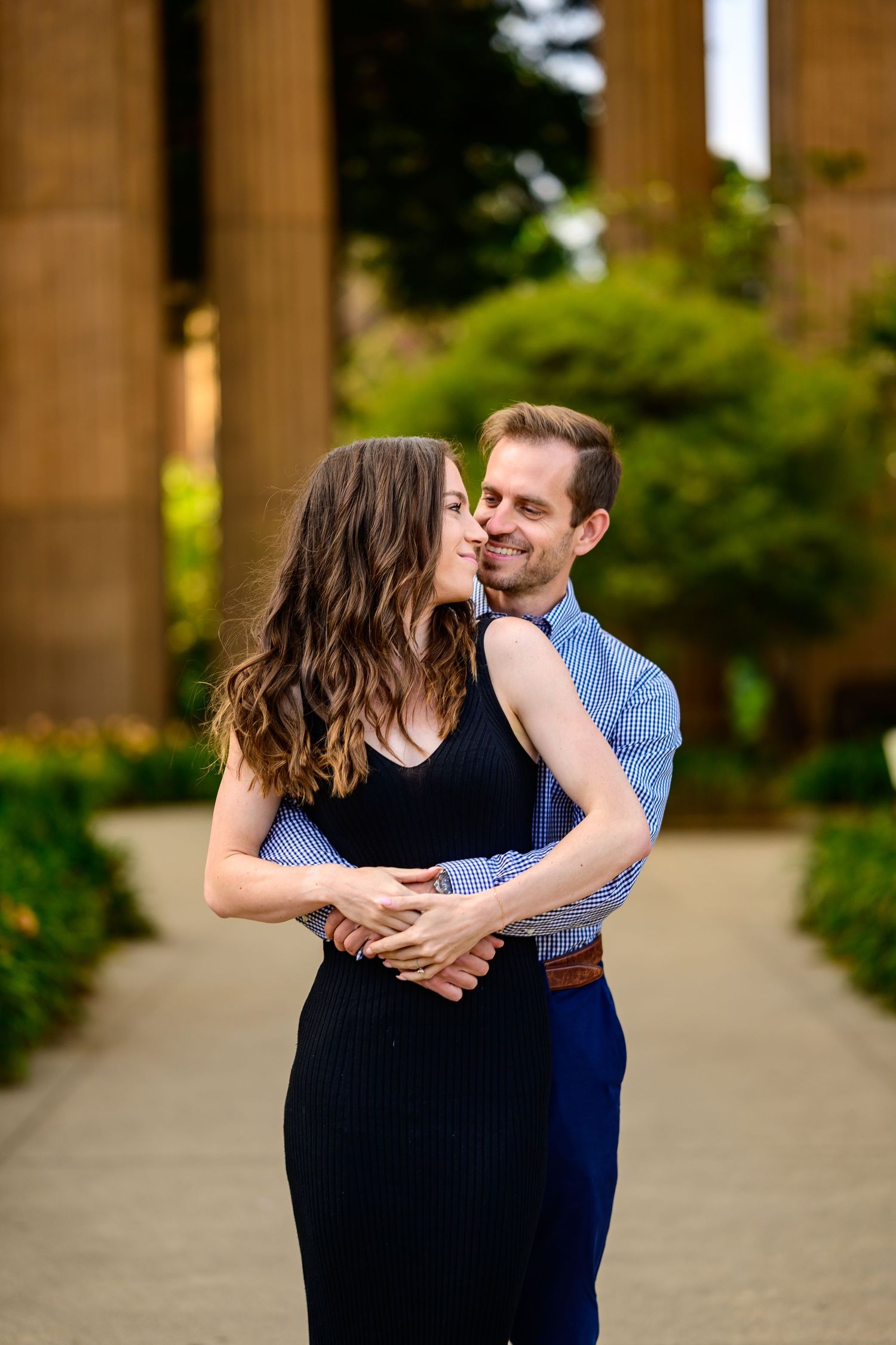 An intimate engagement photo sequence showing tender moments between a couple near columns.