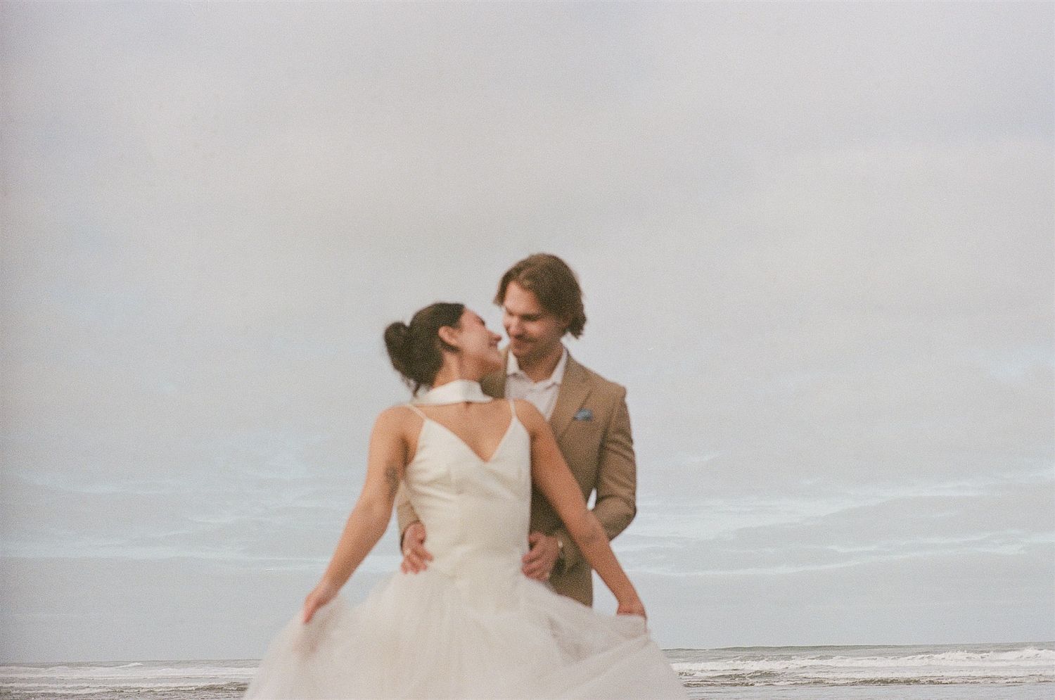 Bride and groom by the ocean