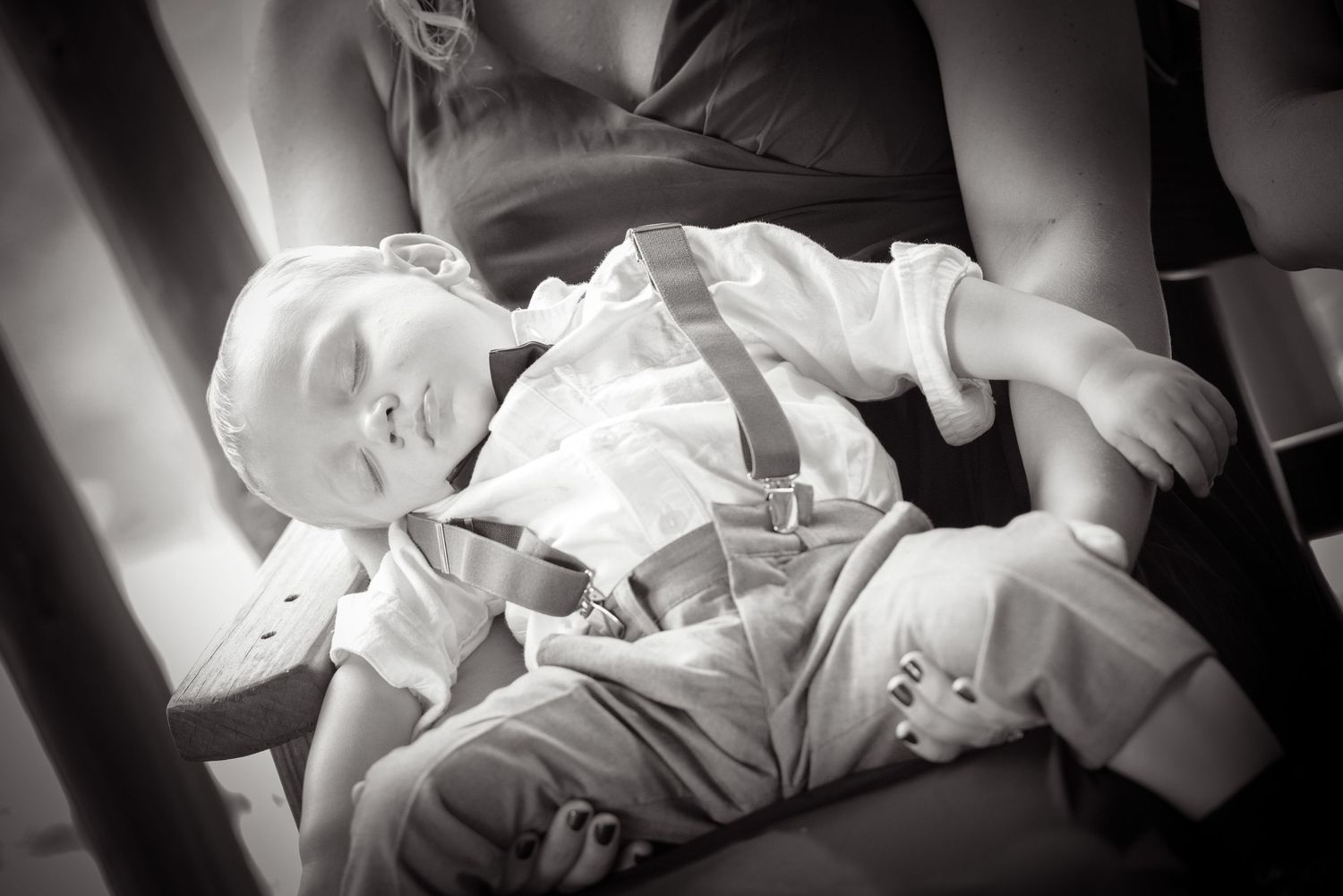 Pigeon Forge Wedding Photographers portrait of a sleeping baby in white clothing rests peacefully in black and white photograph.
