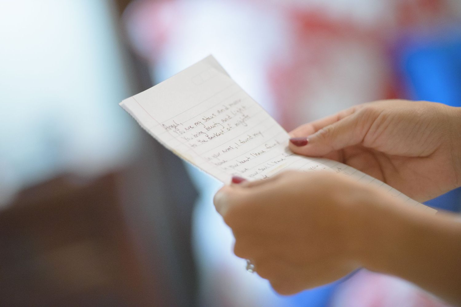 Hands holding a white handwritten note or letter in soft focus in Pigeon Forge TN.