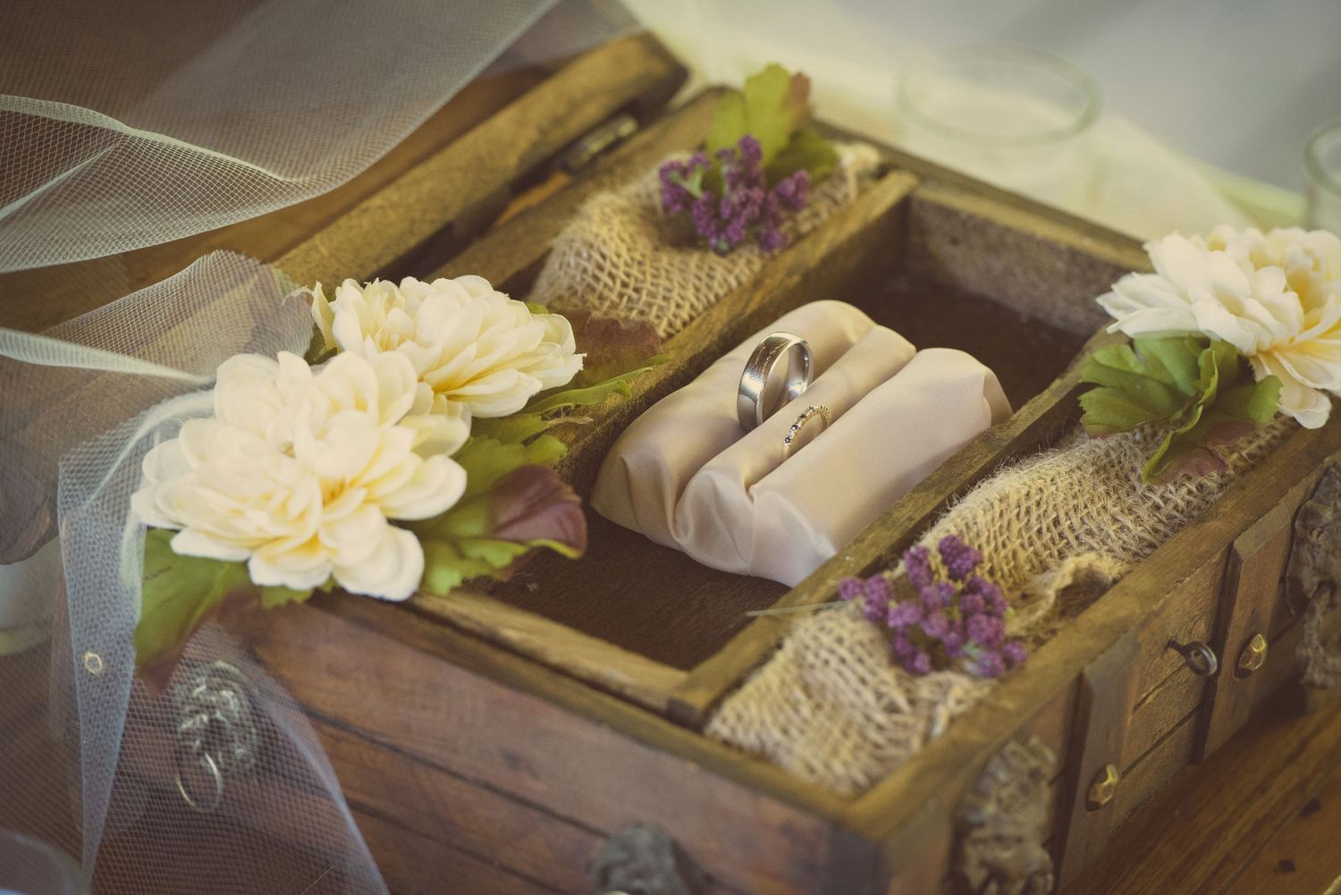 Rustic wooden box filled with wrapped gifts, burlap, flowers and decorative elements in Pigeon Forge TN.