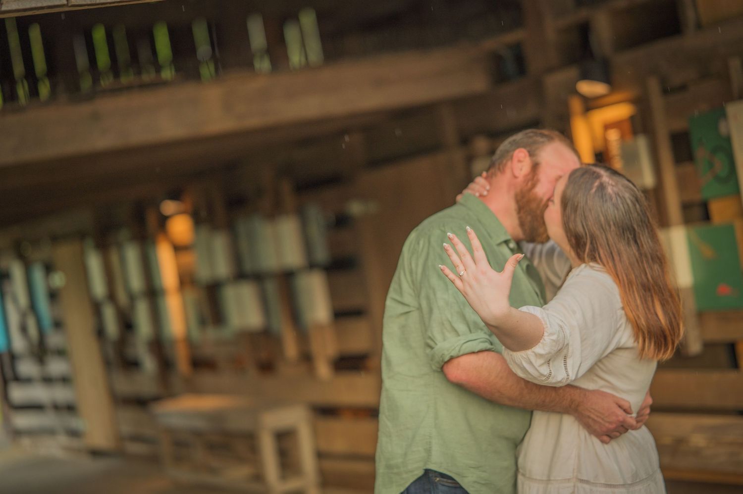 A romantic couple shares an intimate moment on a rustic wooden porch at sunset.