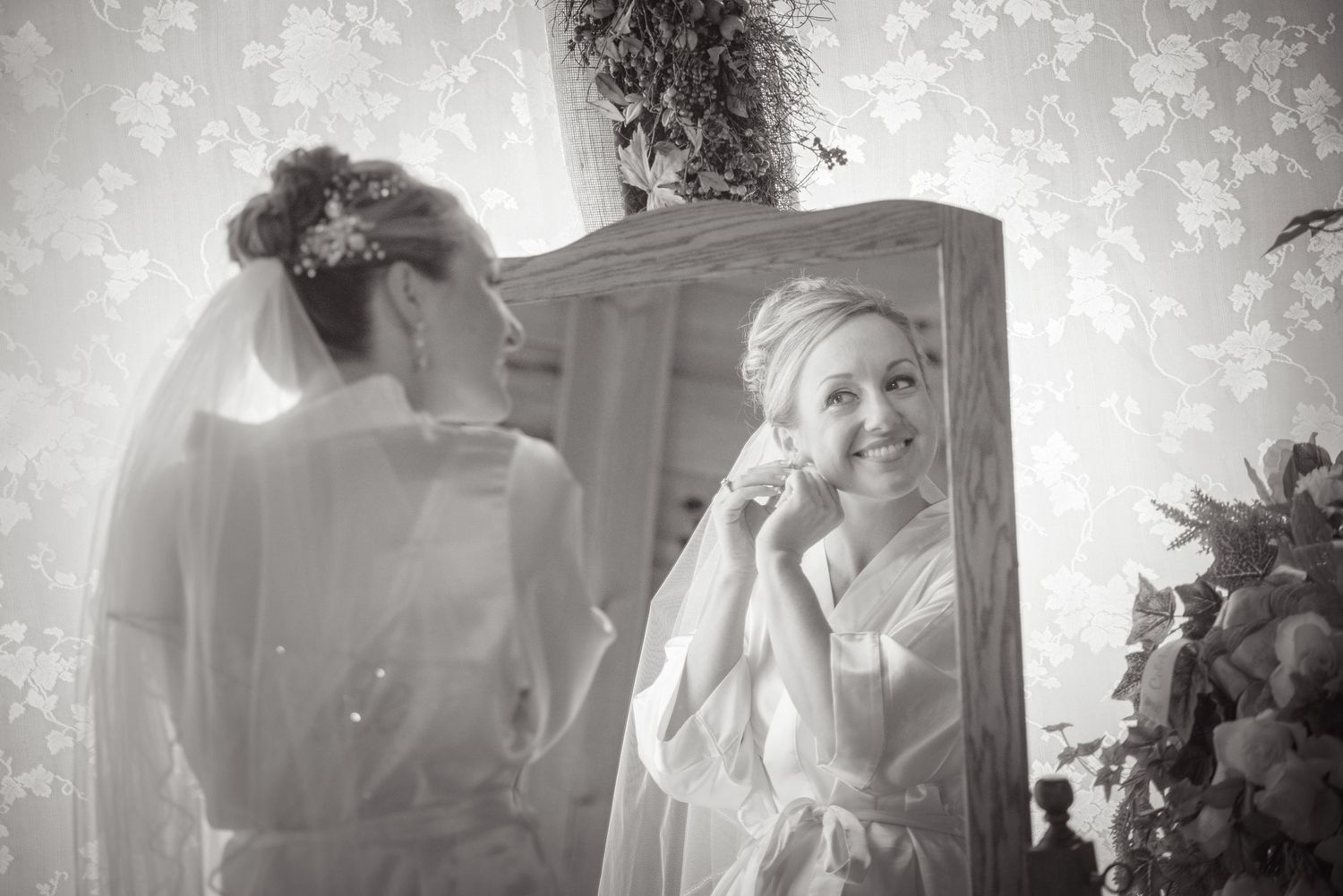 Black and white artistic photograph showing bridal preparation with mirror reflection and ethereal lighting effects in Pigeon Forge TN.