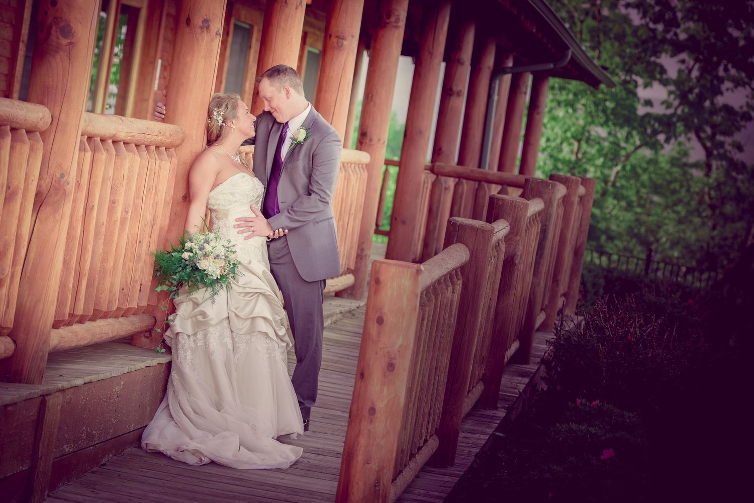 Sevierville wedding Photographers portrait of a romantic wedding couple share an intimate moment on a rustic wooden porch.