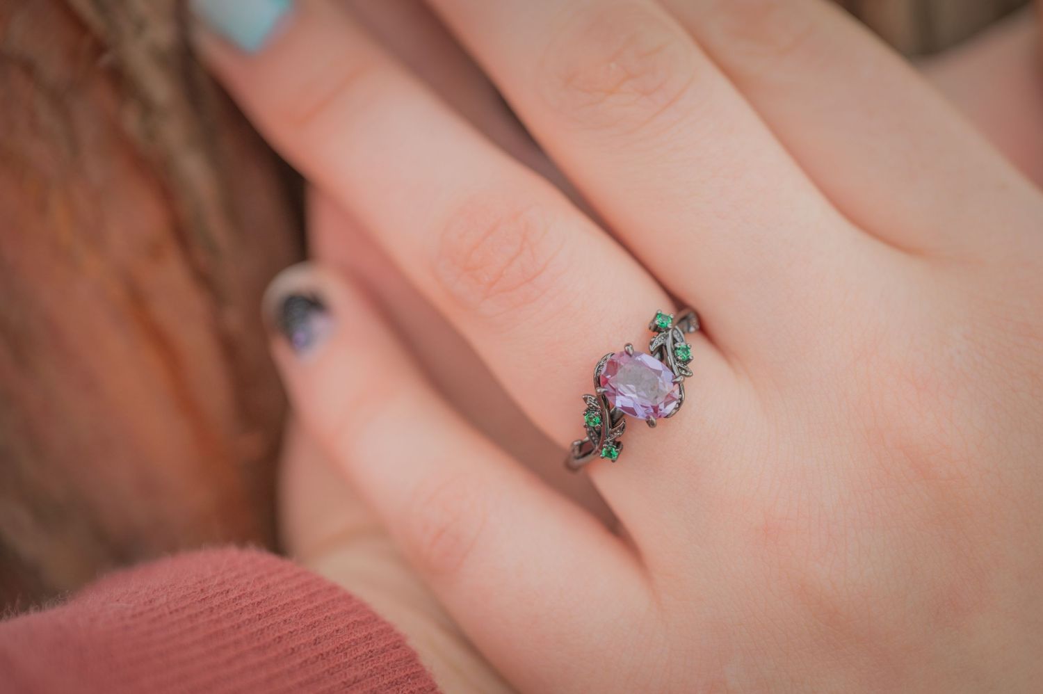 A delicate vintage-style ring featuring an oval pink opal stone surrounded by tiny turquoise and crystal accents in Pigeon Forge.