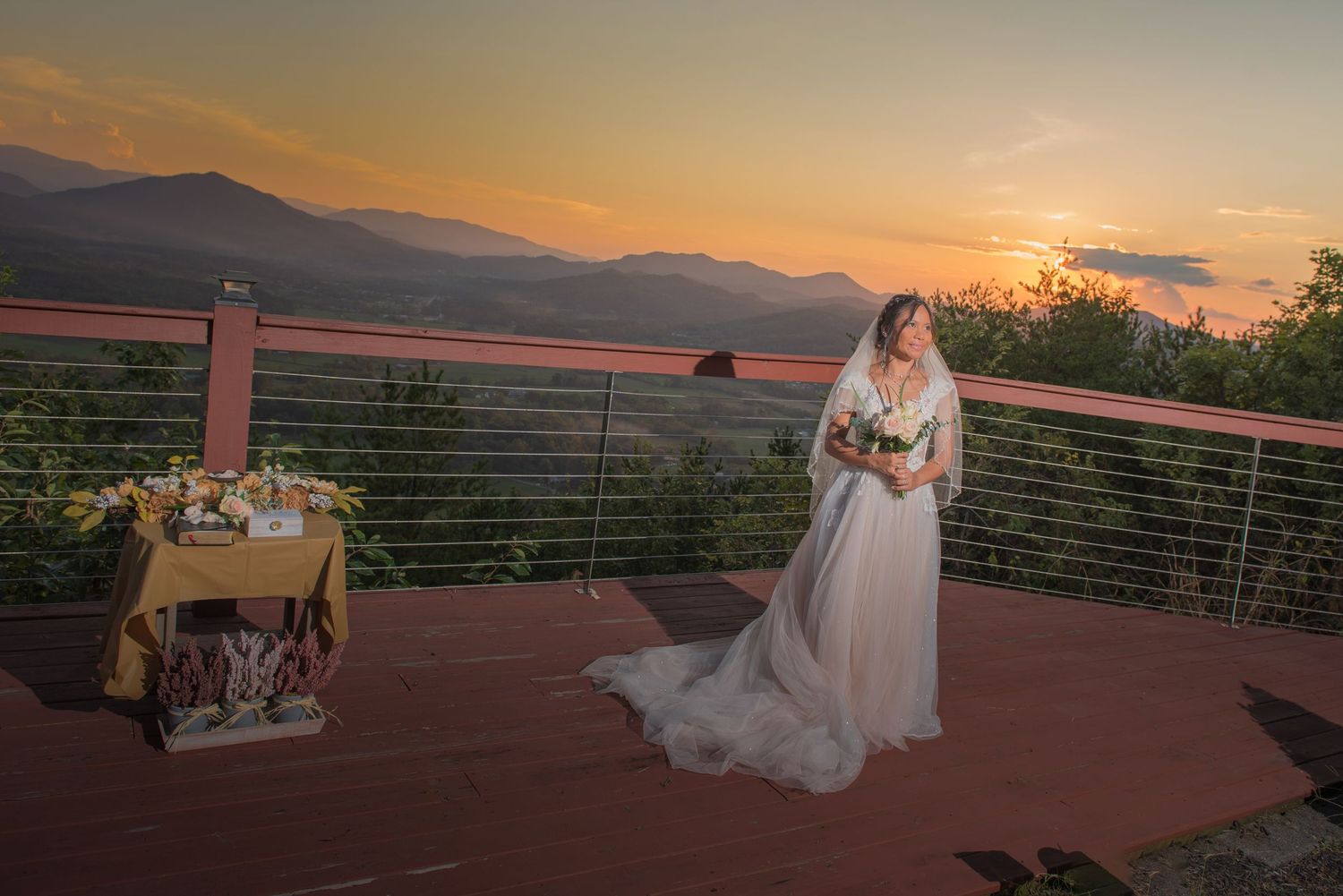 A stunning sunset wedding scene on a mountain terrace with decorative details and scenic views of distant peaks.
