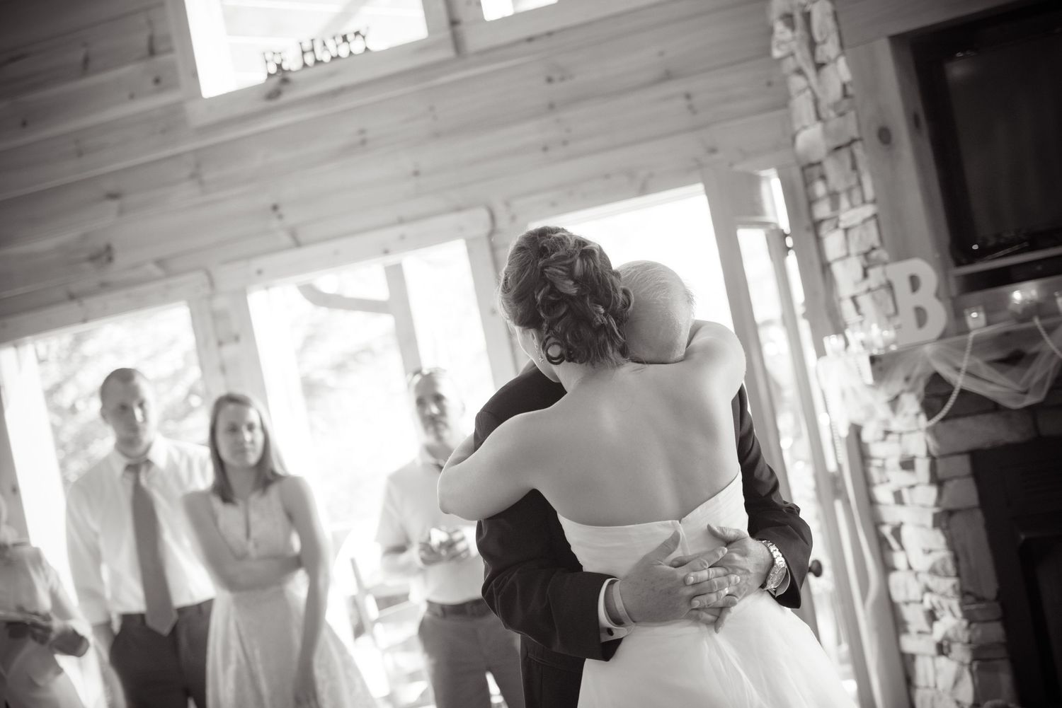 A romantic black and white photo of a couple dancing and embracing during their wedding celebration in Pigeon Forge.