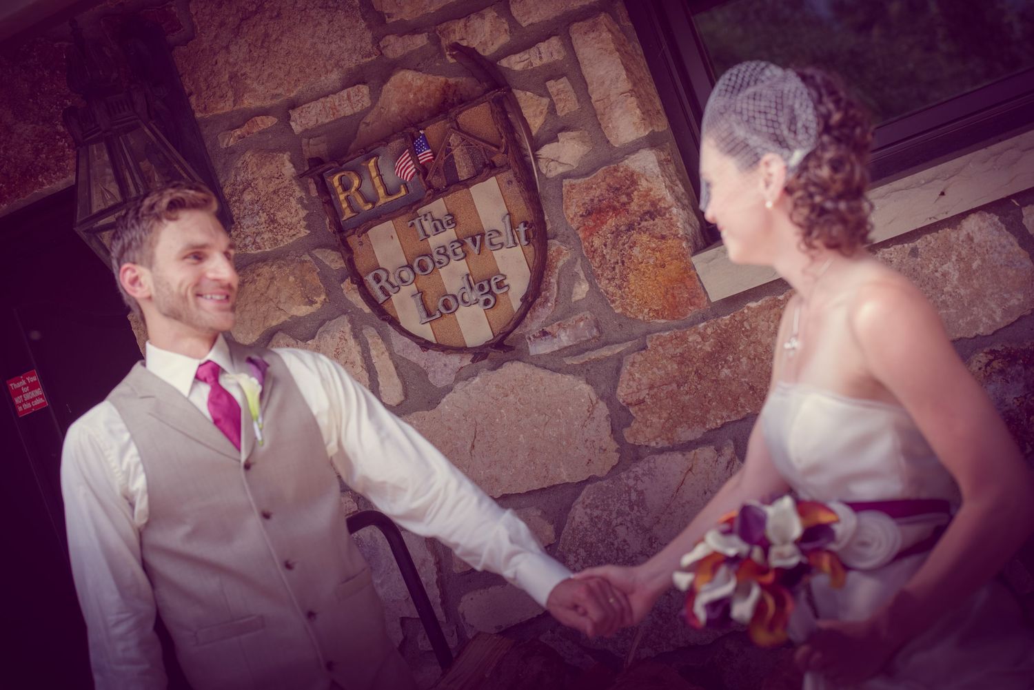 A romantic moment between ta couple at what appears to be a rustic venue during a wedding celebration at the Roosevelt Lodge Gatlinburg.