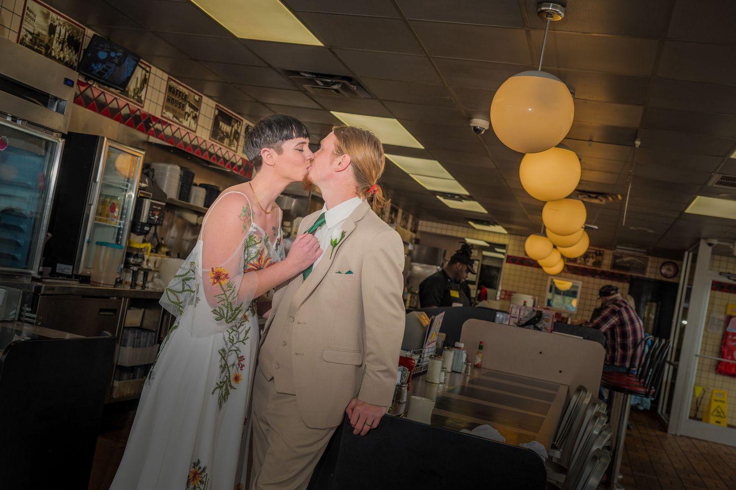 A romantic moment in a waffle house with warm glowing lights and vintage decor by Gatlinburg Wedding Photographers.