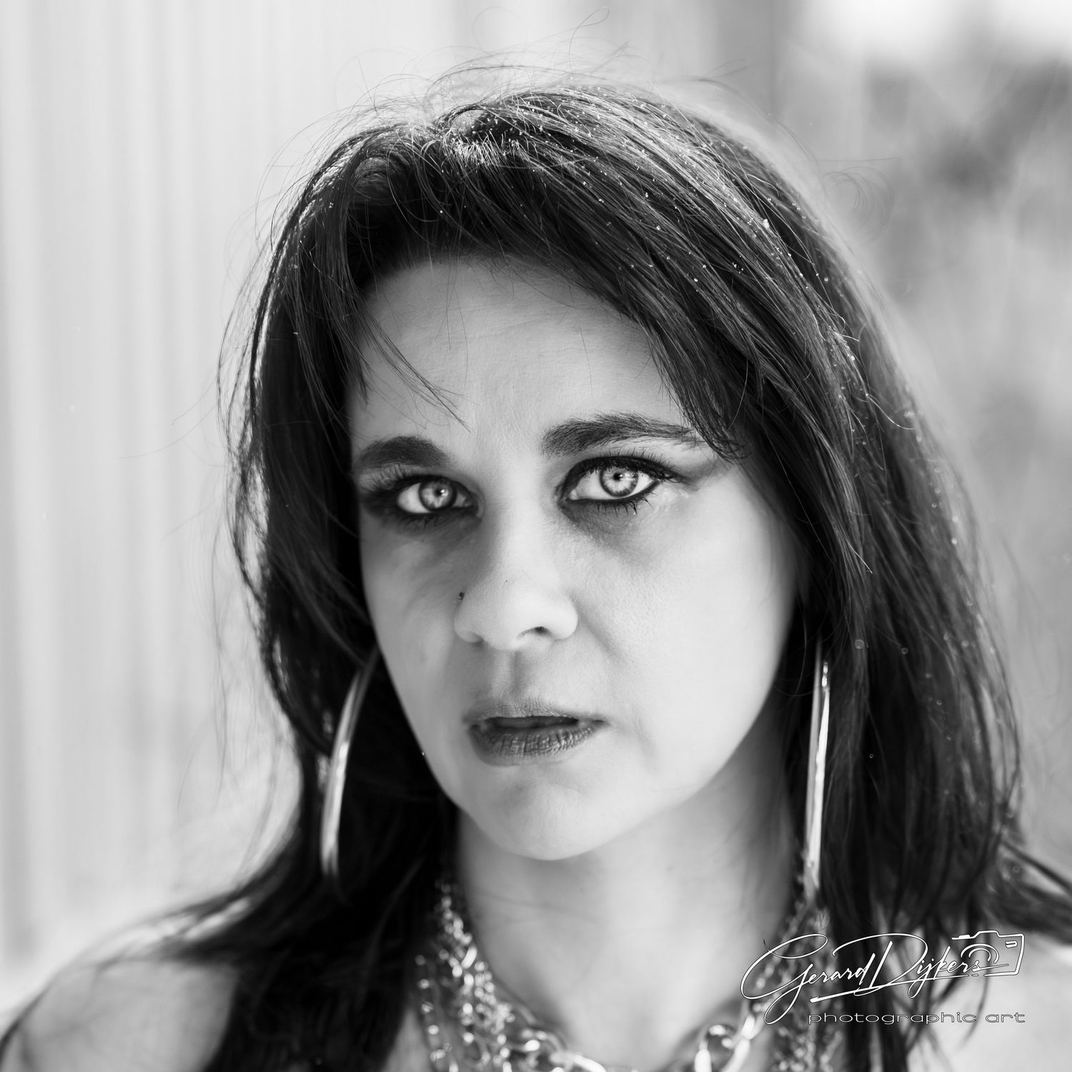 Black and white portrait series showing close-up expressions and poses with dark hair and dramatic lighting.