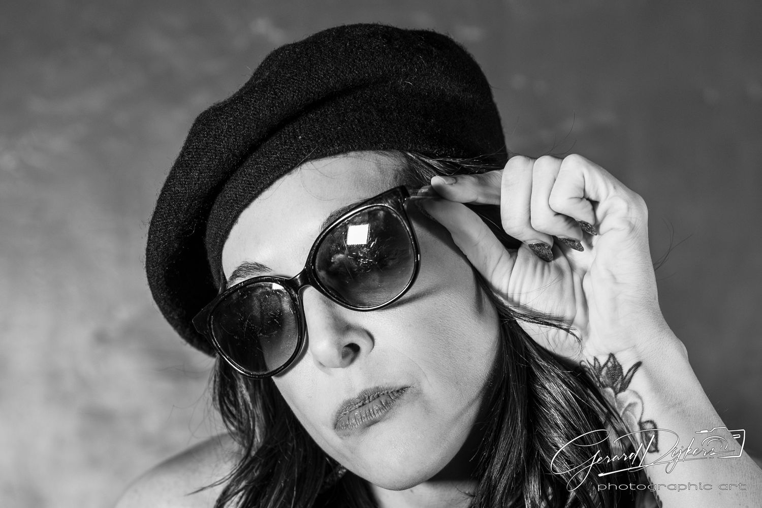 Black and white artistic portrait series showing someone wearing sunglasses and a hat in different expressive poses.