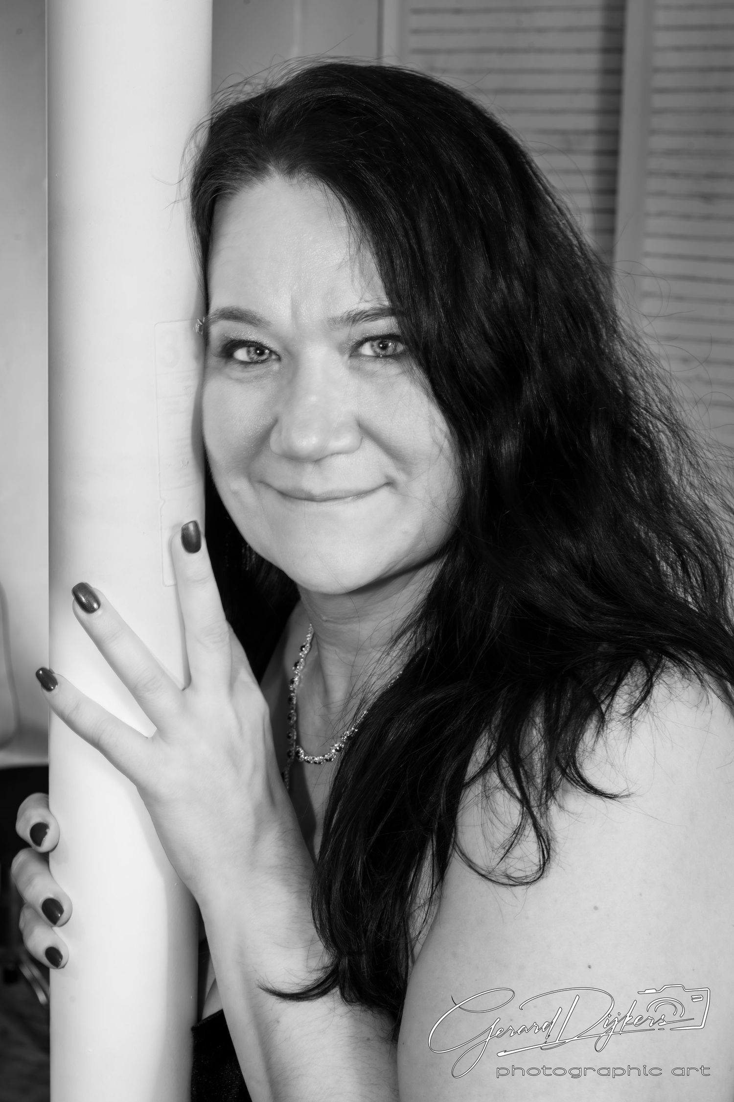 A series of black and white artistic self-portraits showing a person with dark hair posing against a light background.
