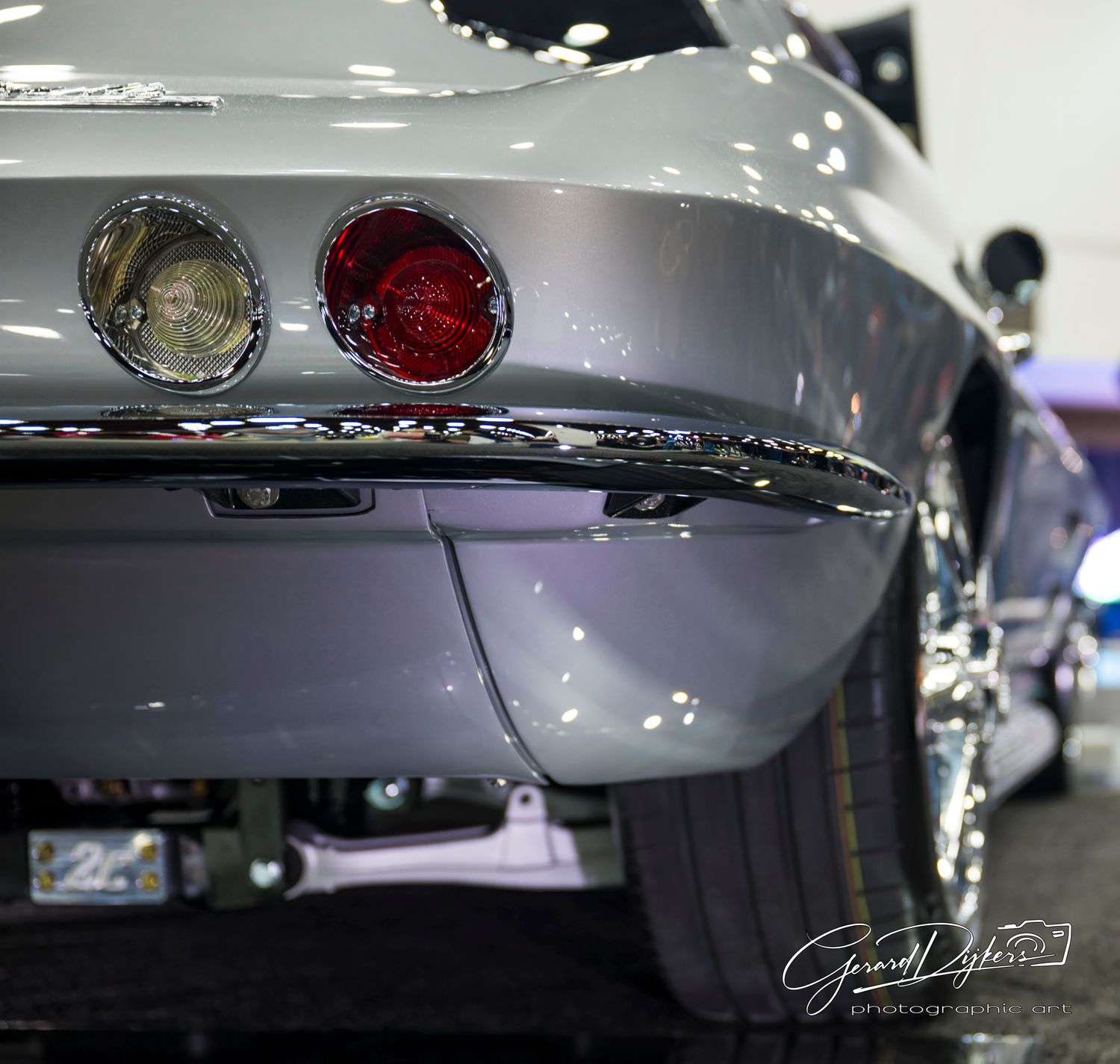 Close-up details of a silver luxury car's exterior showing reflective surfaces and chrome trim elements.