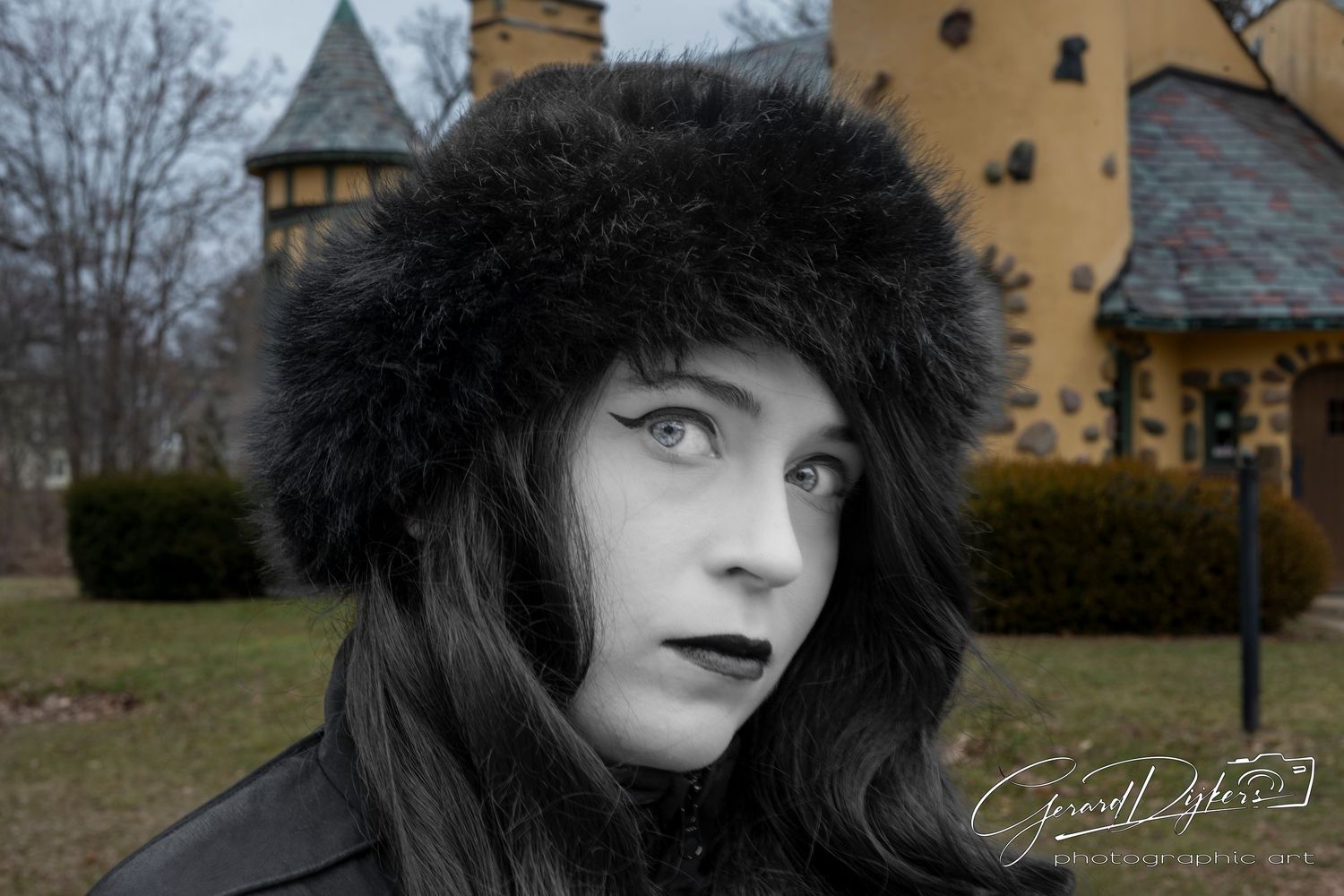A series of moody black and white portraits set against a yellow building and winter landscape.