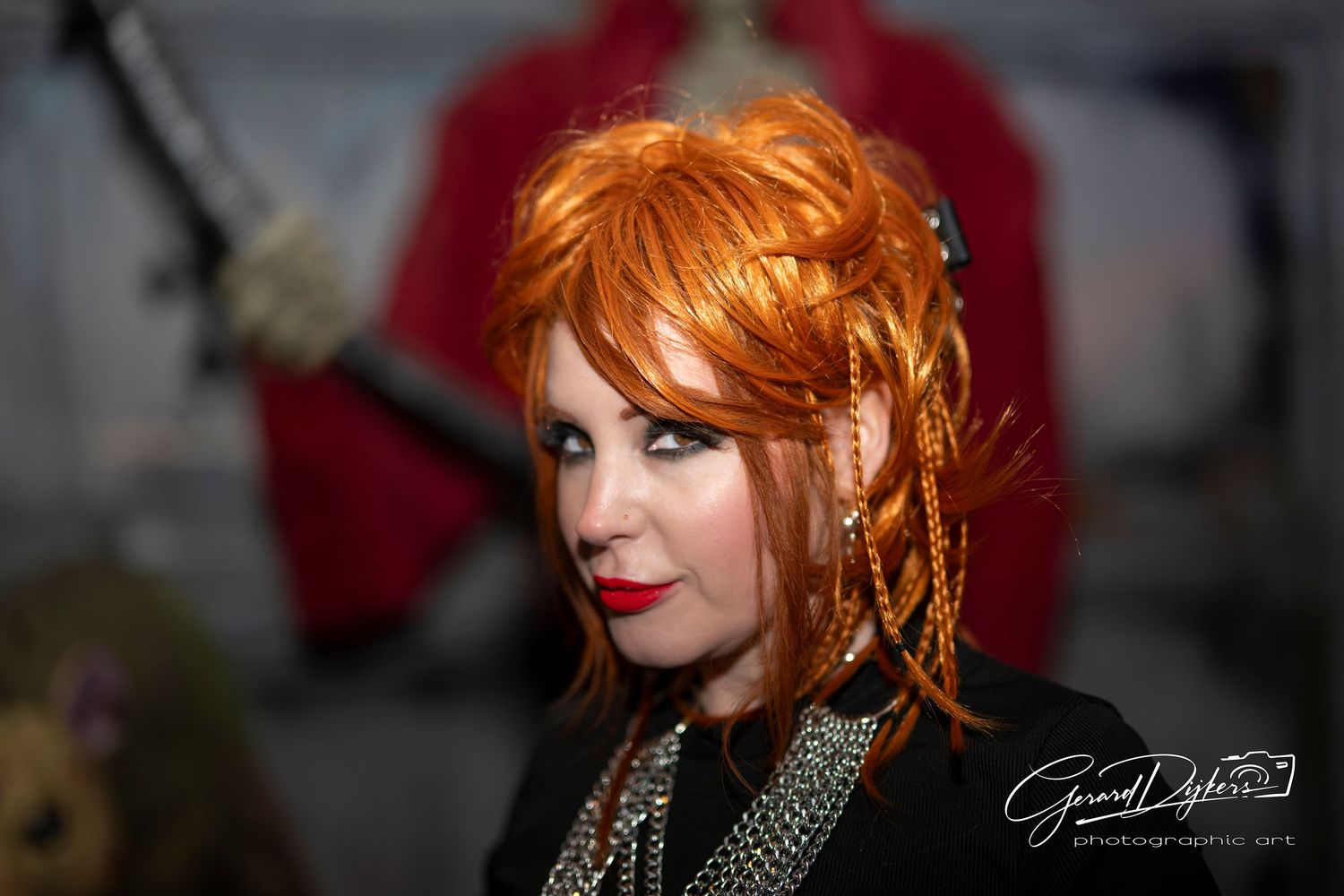 A collection of artistic portraits featuring a woman with vibrant red hair and dramatic makeup in various poses.