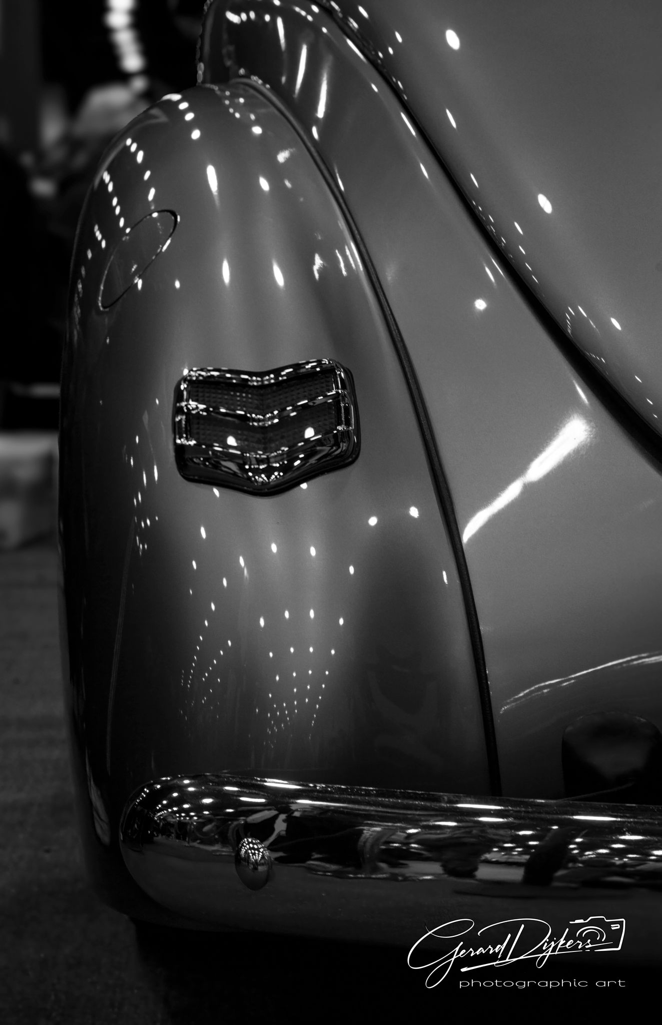 Black and white close-up photographs of a classic car's curved fender showing glossy reflective surfaces and highlights.