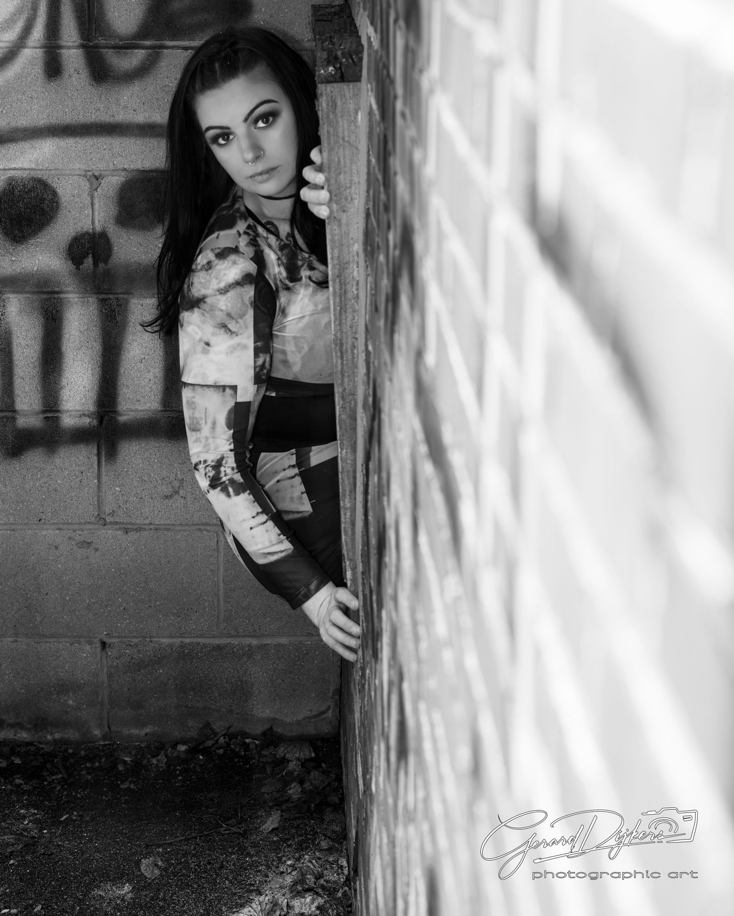 A black and white artistic portrait series shows a figure peeking from behind a wall in dramatic lighting.