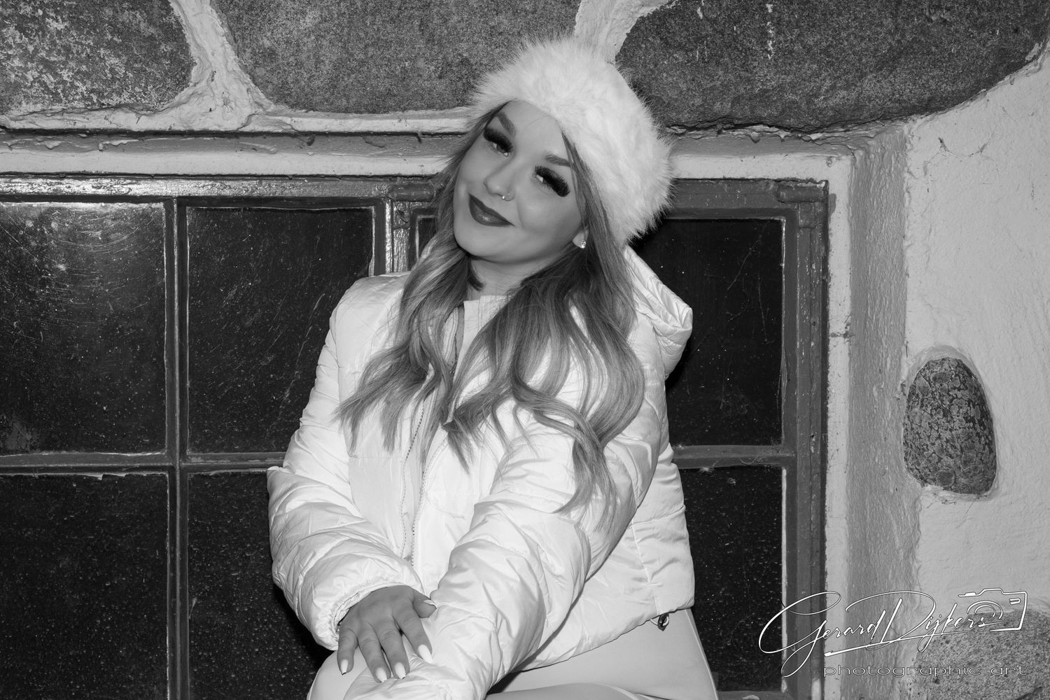 A series of black and white photographs showing someone posing against walls and doorways in various outfits.