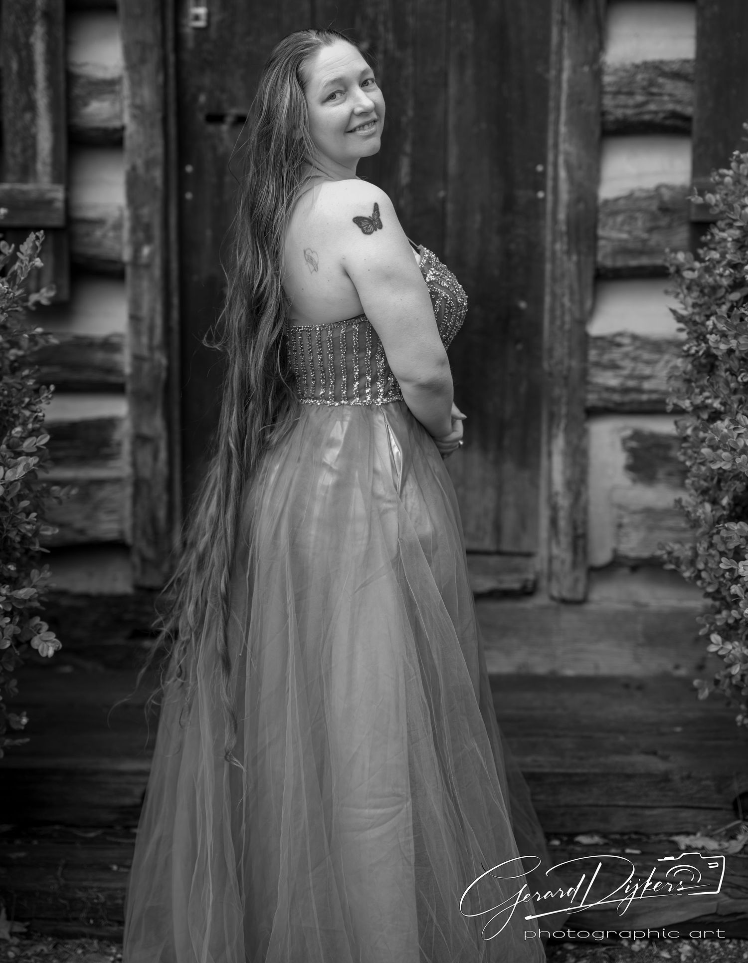 A black and white artistic portrait series showing a woman in a flowing tulle gown posing against a rustic wooden backdrop.