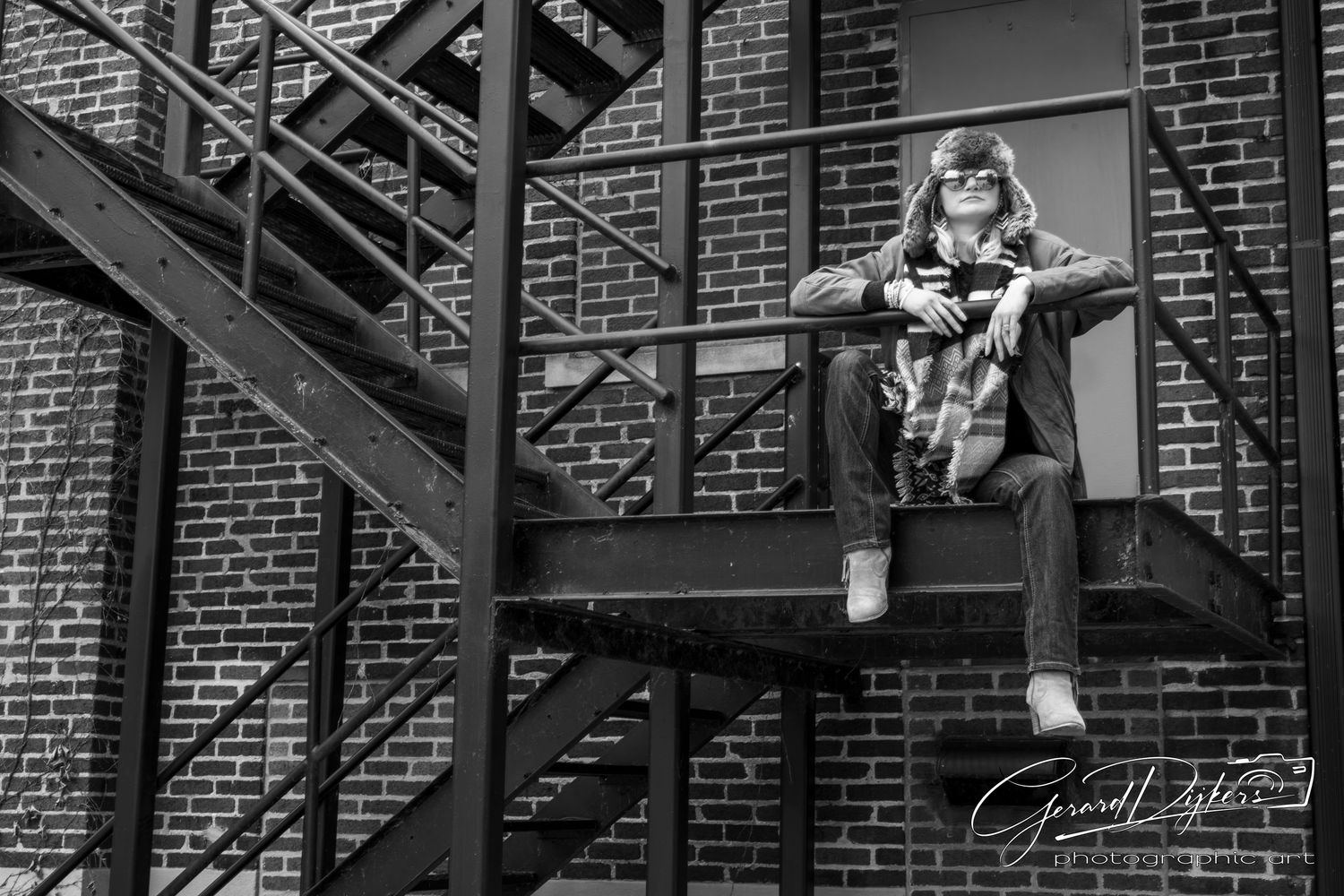 Black and white photo series showing skateboarders performing tricks on stairs and handrails against brick walls.