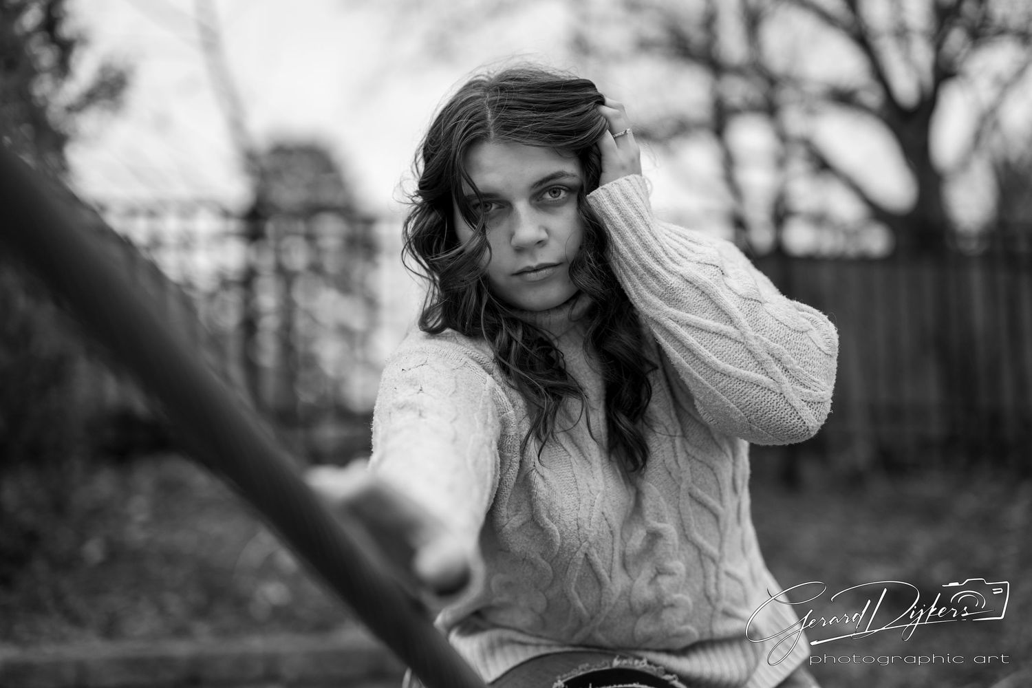 A series of black and white portraits showing someone in a white dress posing outdoors near trees.