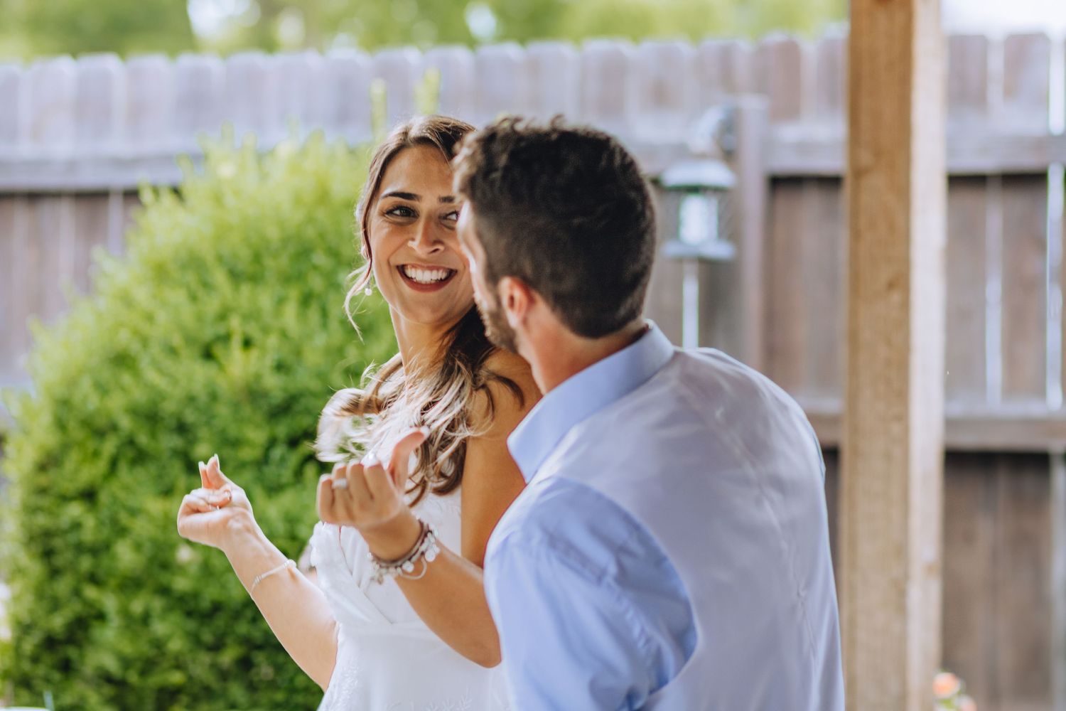 Four sequential photos show a precious engagement moment in front of a garden backdrop.