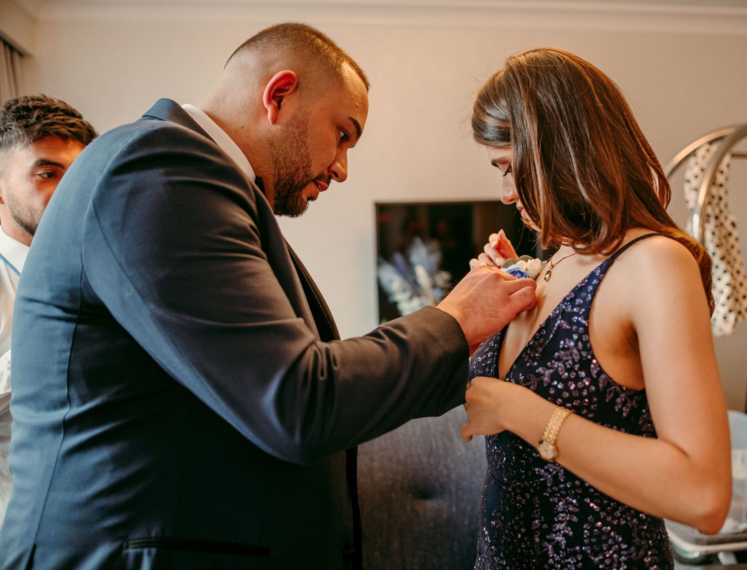 Several well-dressed couple pairs dance closely together on a dance floor at an elegant event.