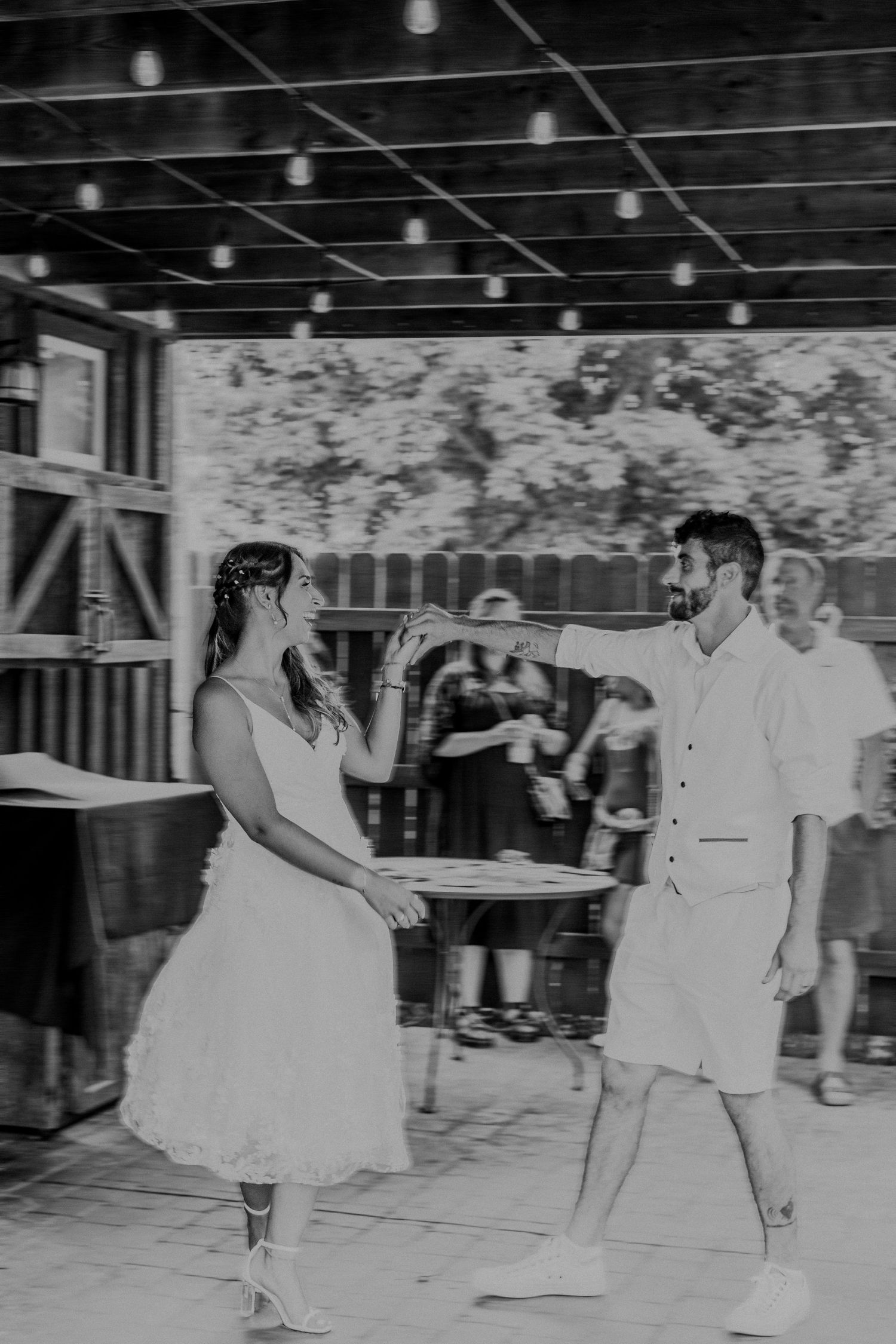 Two people dancing together at a social event in vintage black and white photograph.