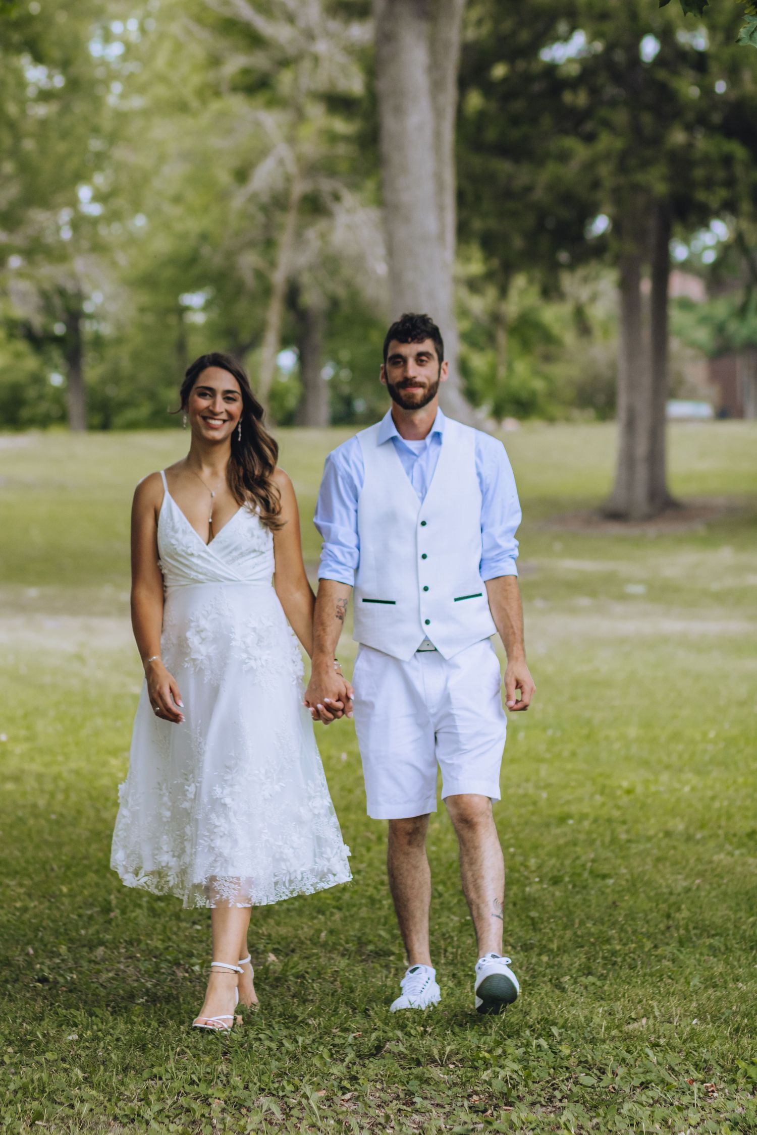 A couple in matching white outfits walking on grass during a sunny day, shown in a series of candid photos.