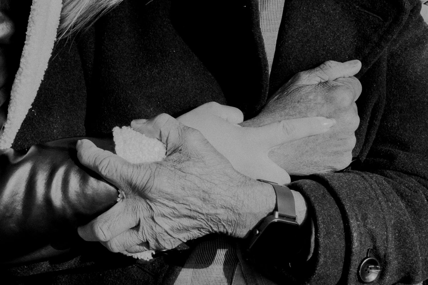 Black and white close-up of hands being held together showing rings.