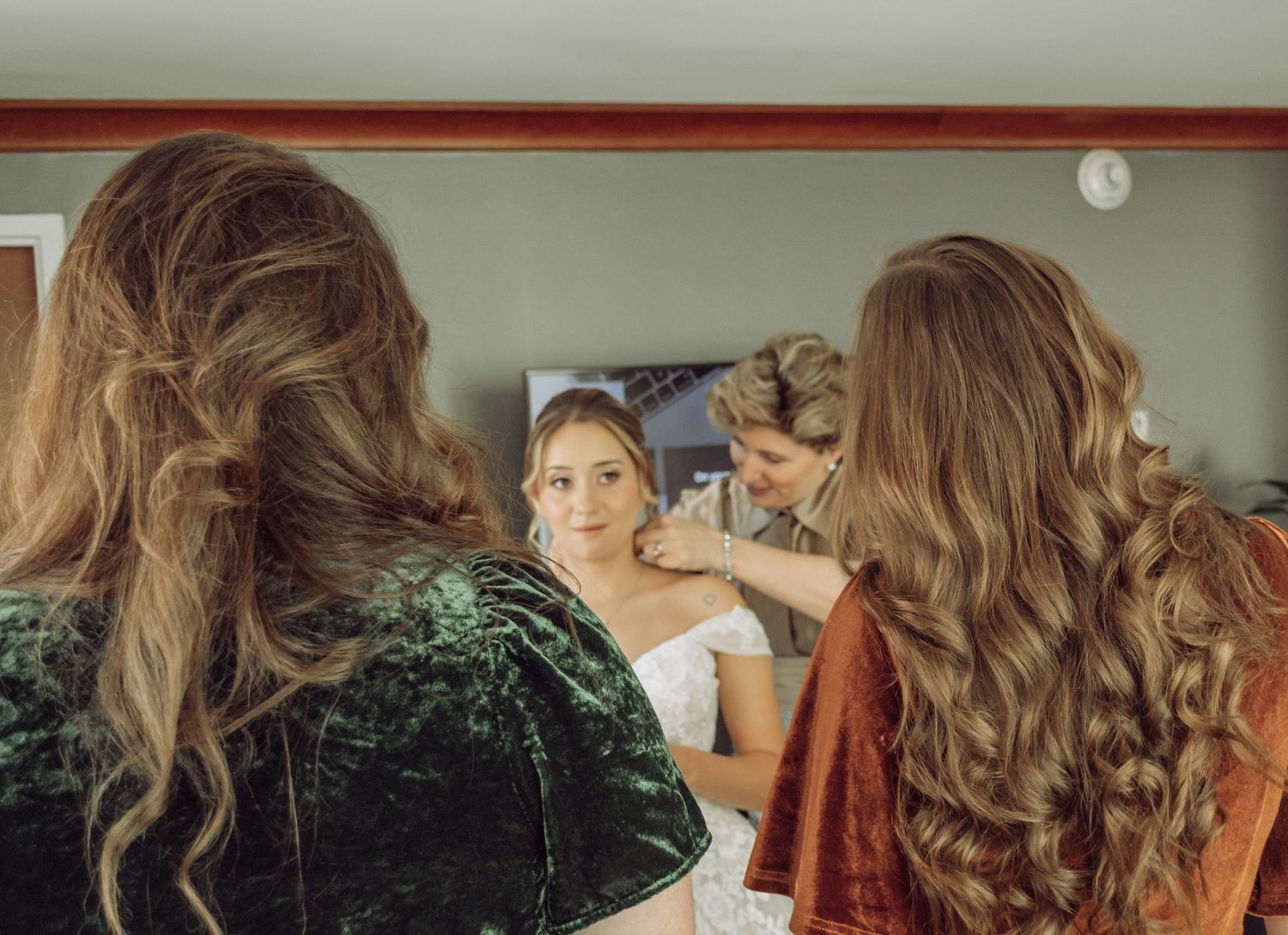 Close-up shots of wedding hair styling showing long curled brunette hair from various angles.