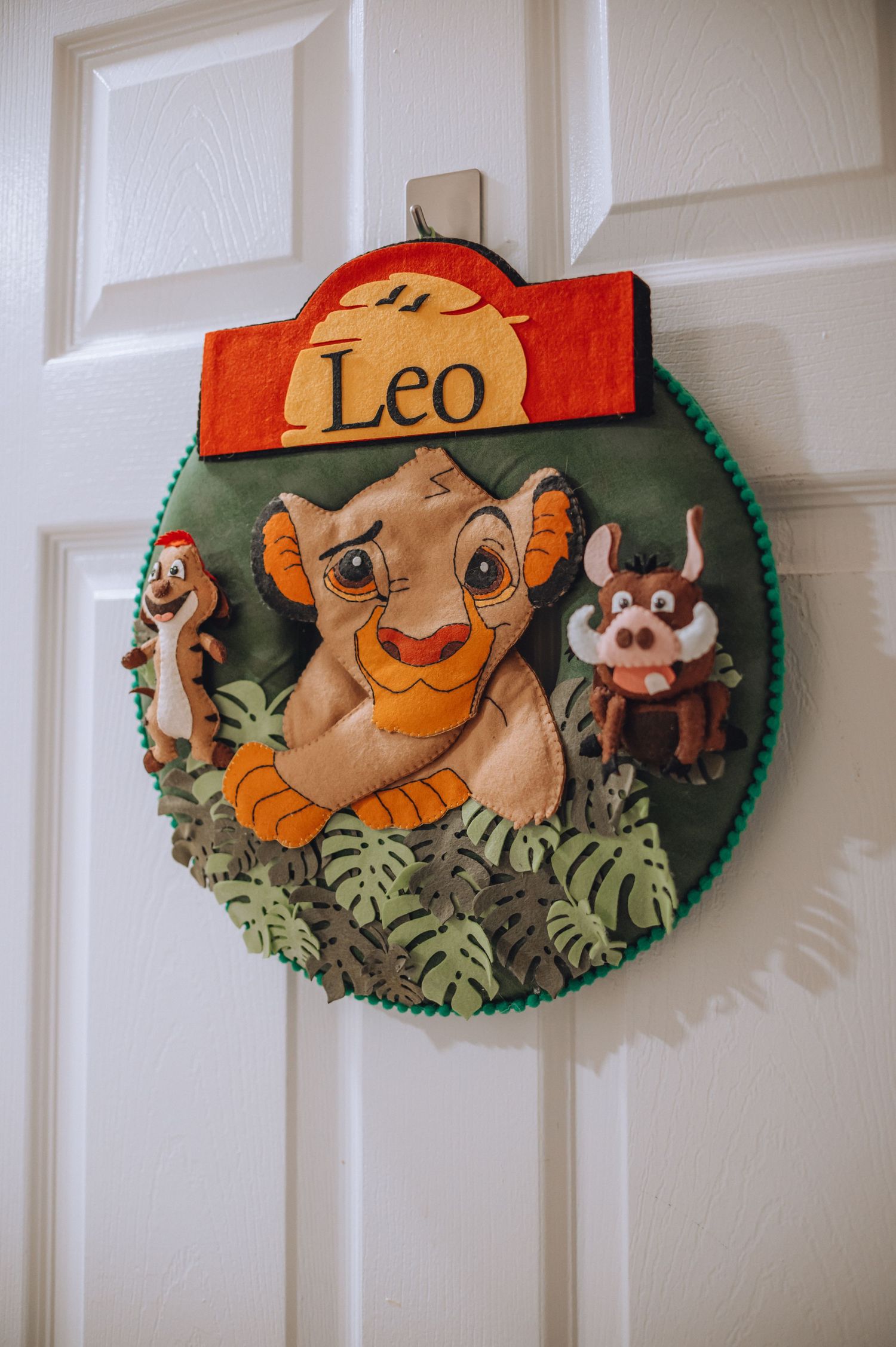 Lion King themed door decoration with Leo name tag and jungle motifs.